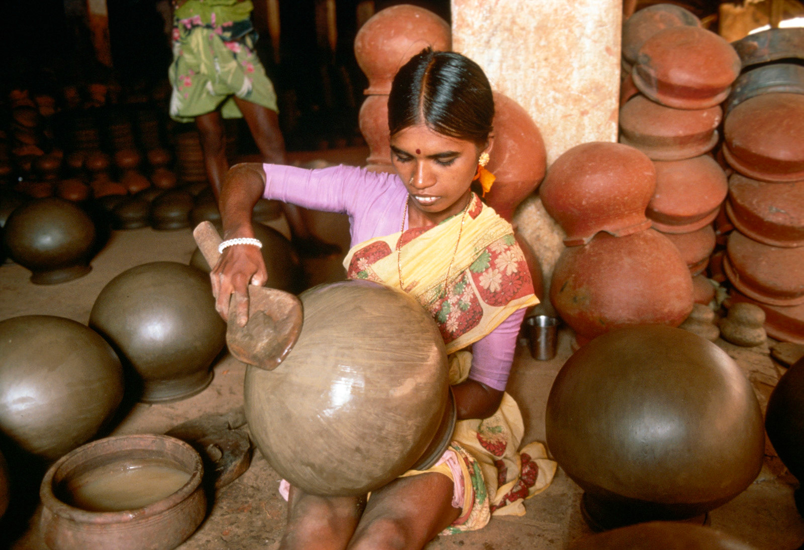 Village potter shaping a pot. Tamil Nadu, India