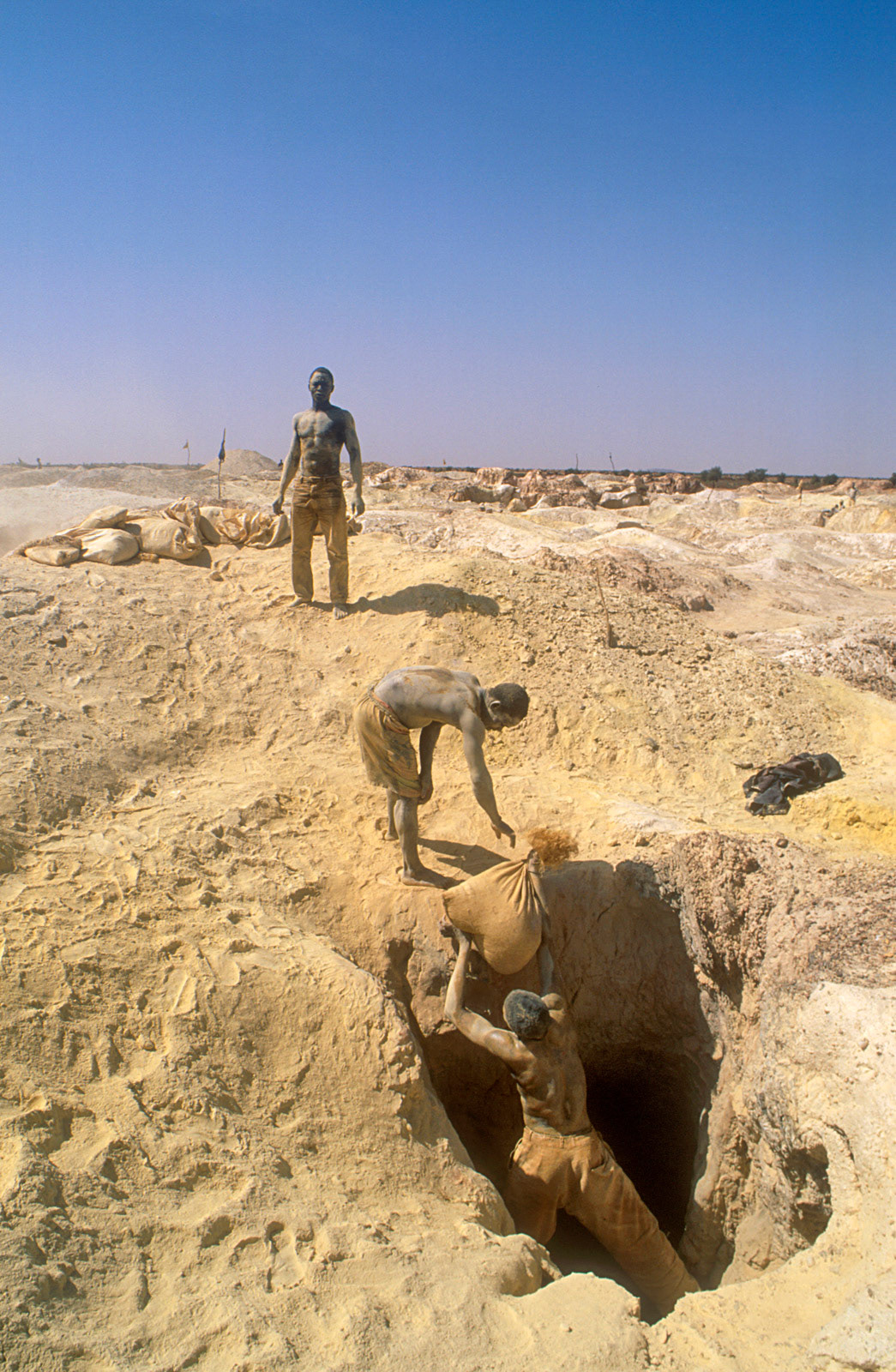 Miners working in a dangerous goldfield, Essakane, Burkina Faso