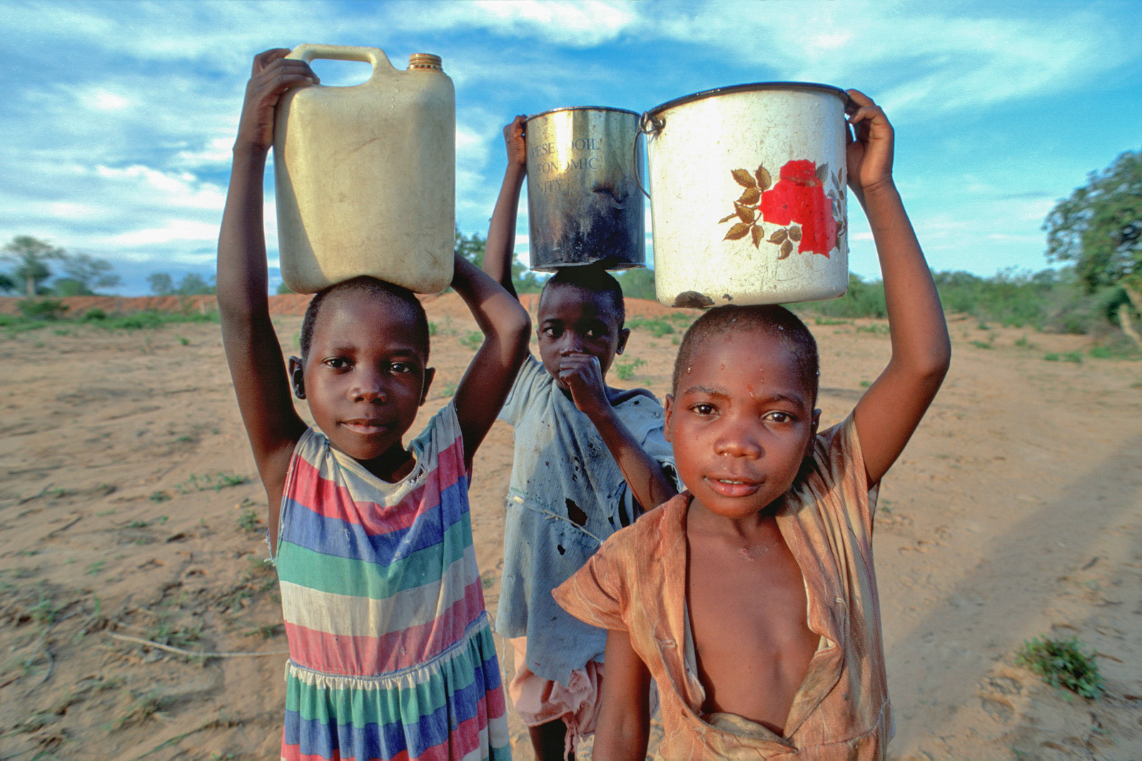 Carrying water home. Nr Binga, Zimbabwe