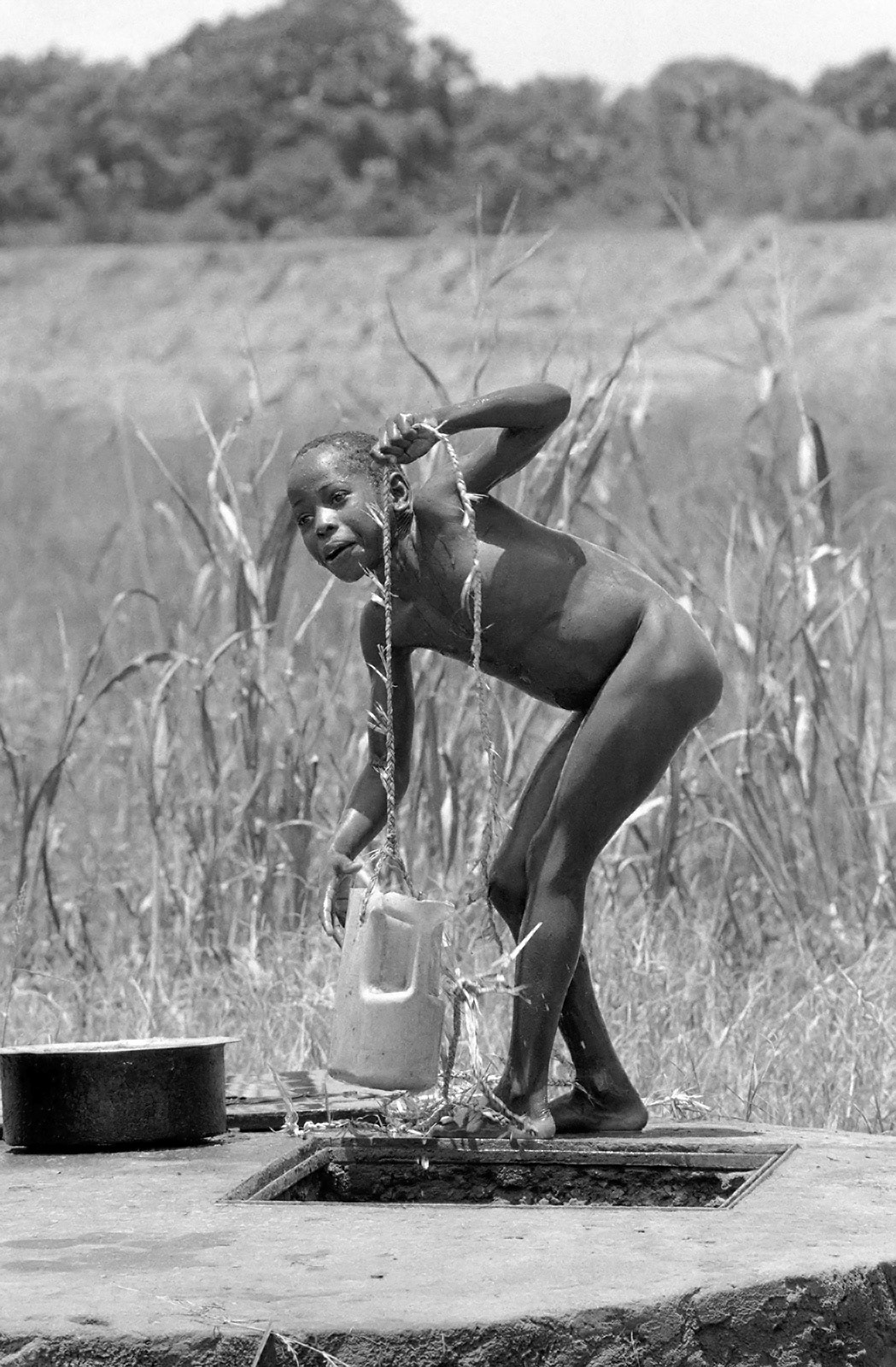Boy washing at water well. Kakoneni, Malindi, Kenya