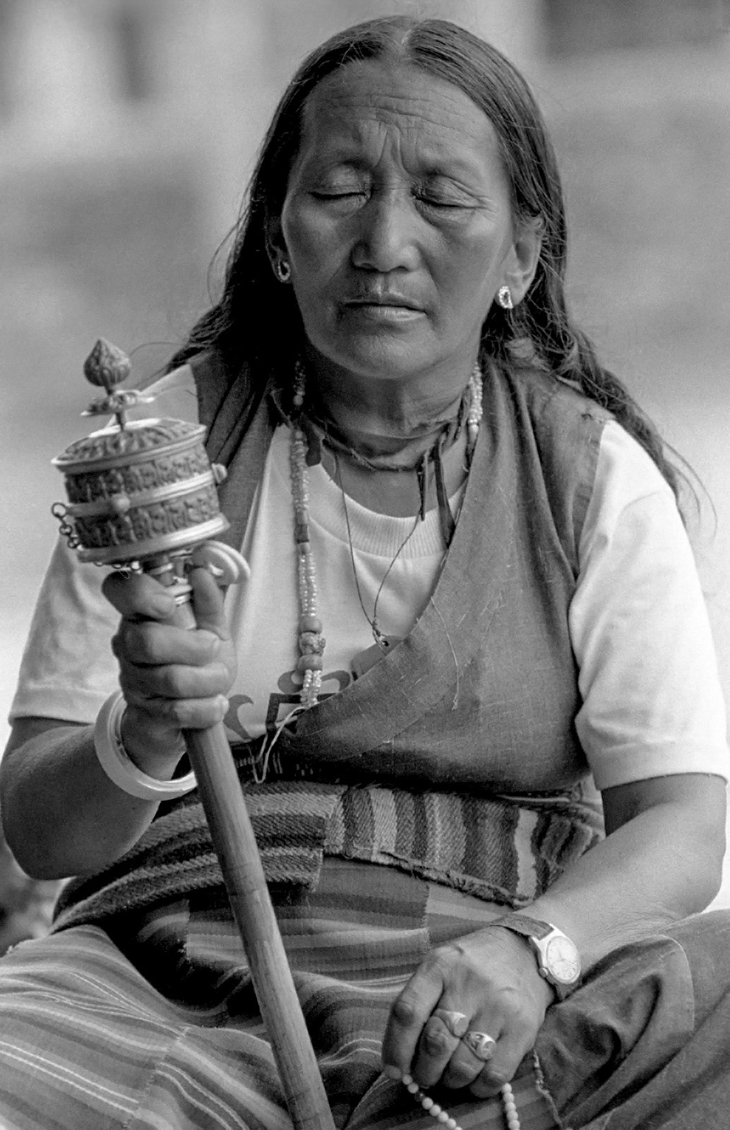 Tibetan refugee with her prayer wheel. Pokhara, Nepal