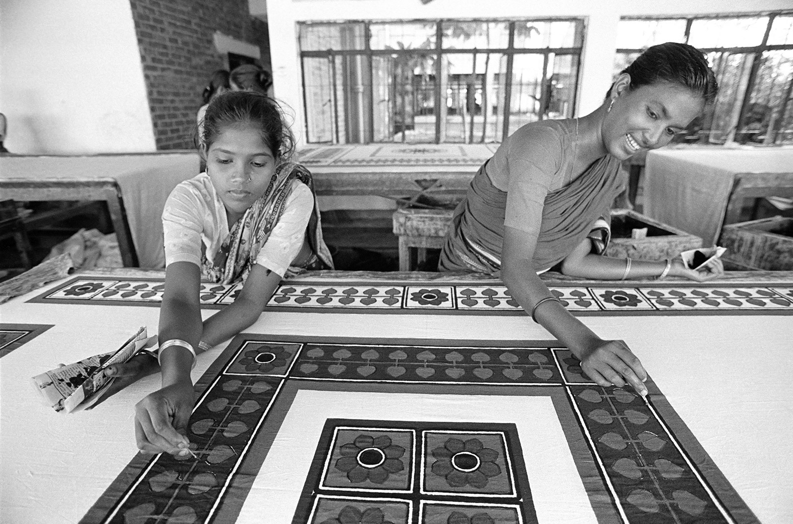 Textile workers retouching block-printed fabric.. Narayanganj, Bangladesh