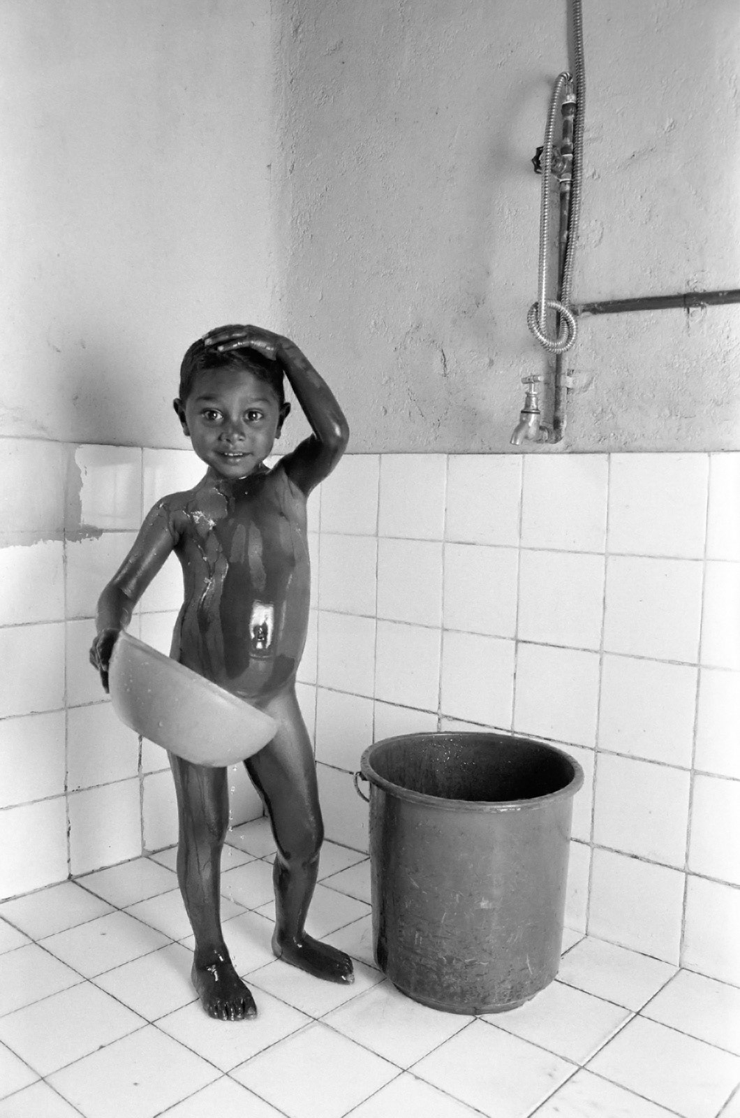 Bathing in bathroom funded by UK charity for tea estate workers. Sri Lanka