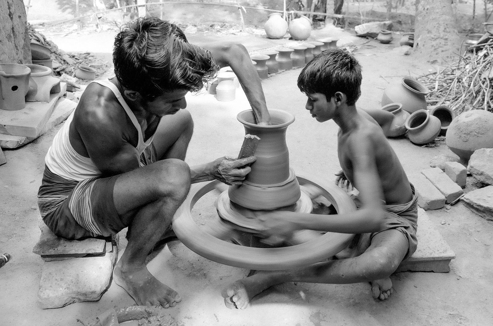Potter and young assistant. Sri Lanka