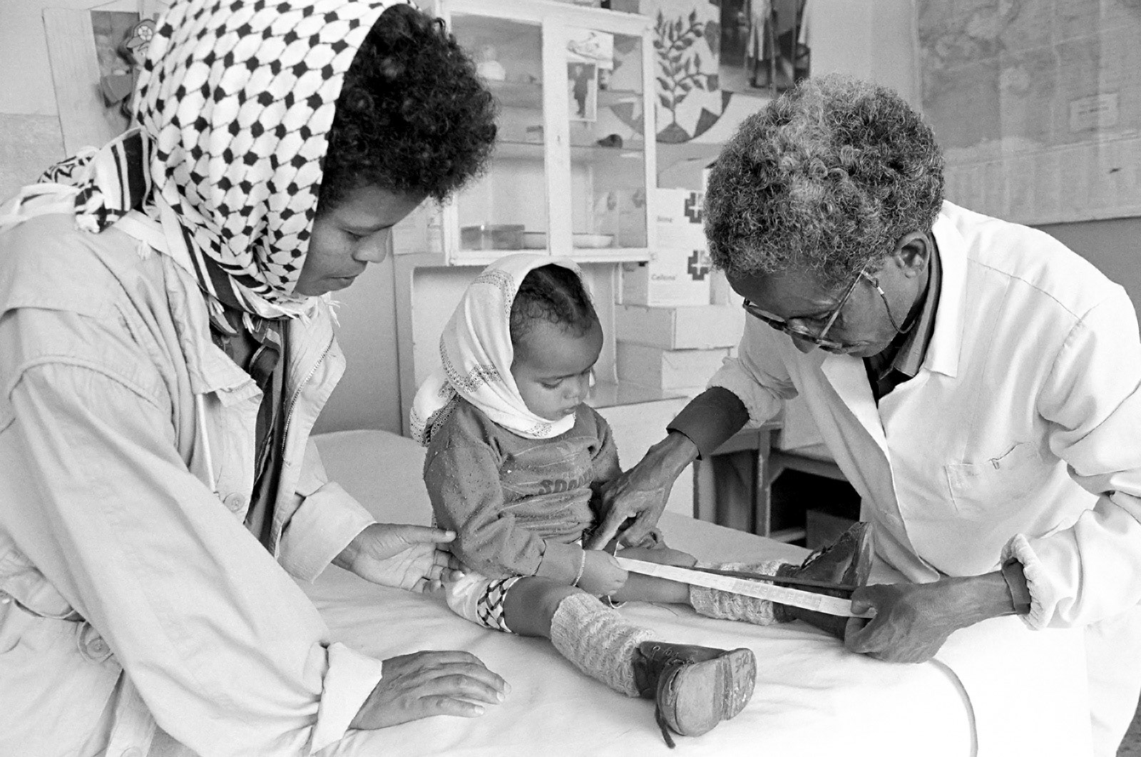 Measuring a young child with polio for new calipers. Asmara, Eritrea