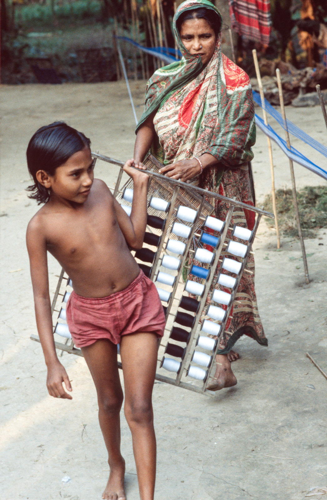 Preparing cotton for weaving. Rajoir, Bangladesh