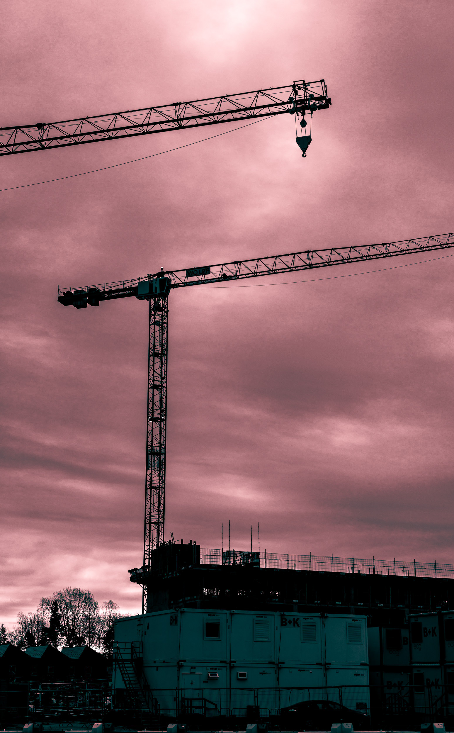 Dystopian Construction. The ominous sky seemed to reinforce the stark construction scene, devoid of nature apart from a few leafless, seemingly-lifeless tress on the horizon. Telford.