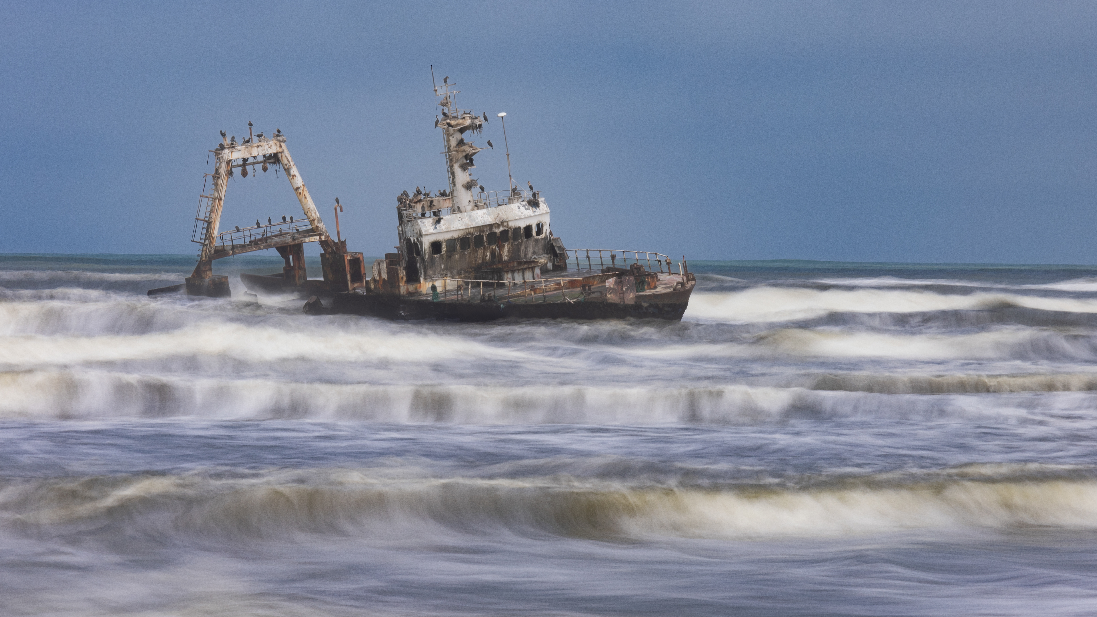 Zeila - The Zeilia ran aground on the Skeleton Coast in 2008. The long exposure gives intresting bands of waves across the sea. Skeleton Coast, Namibia.