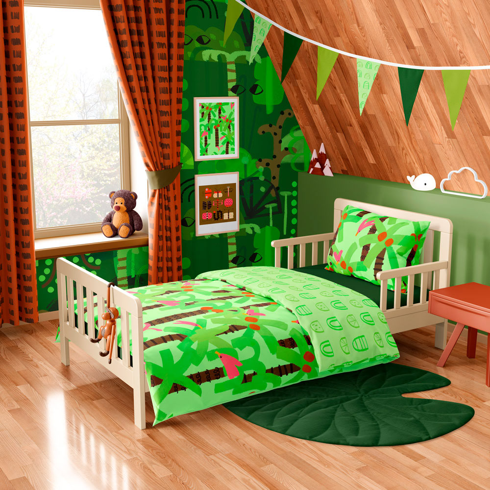 Jungle pattern collection for children in a painterly style shown in a bedroom as posters, curtains, wallpaper and bedding.