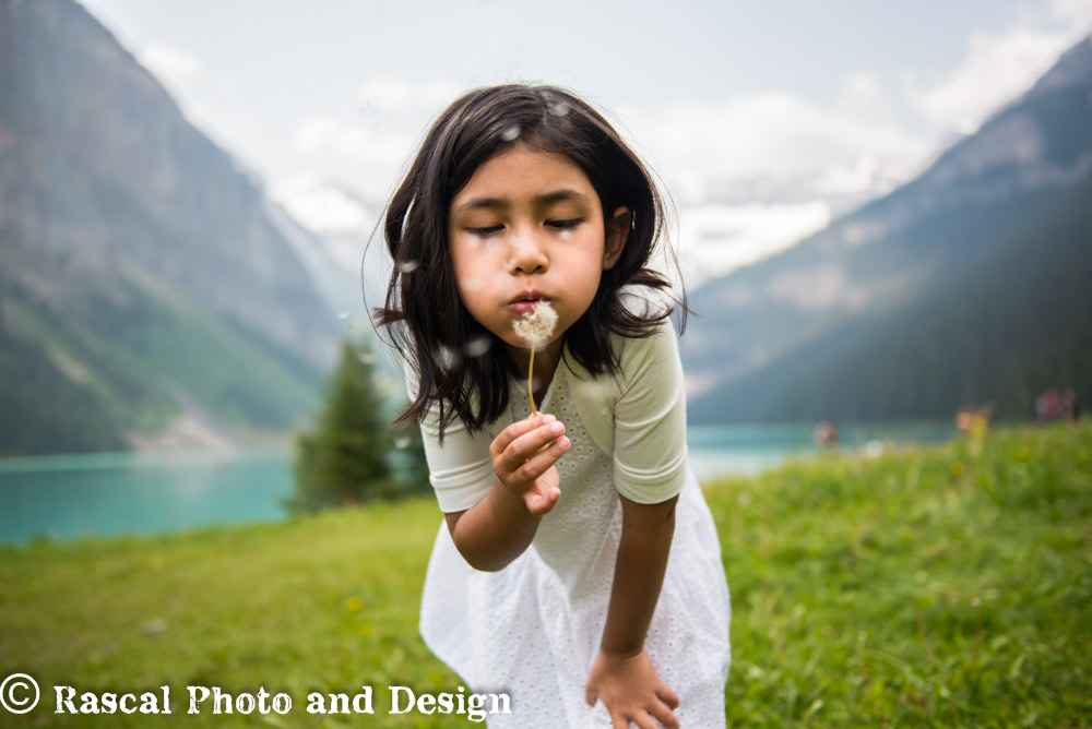 girl with dandelion at Lake Louise