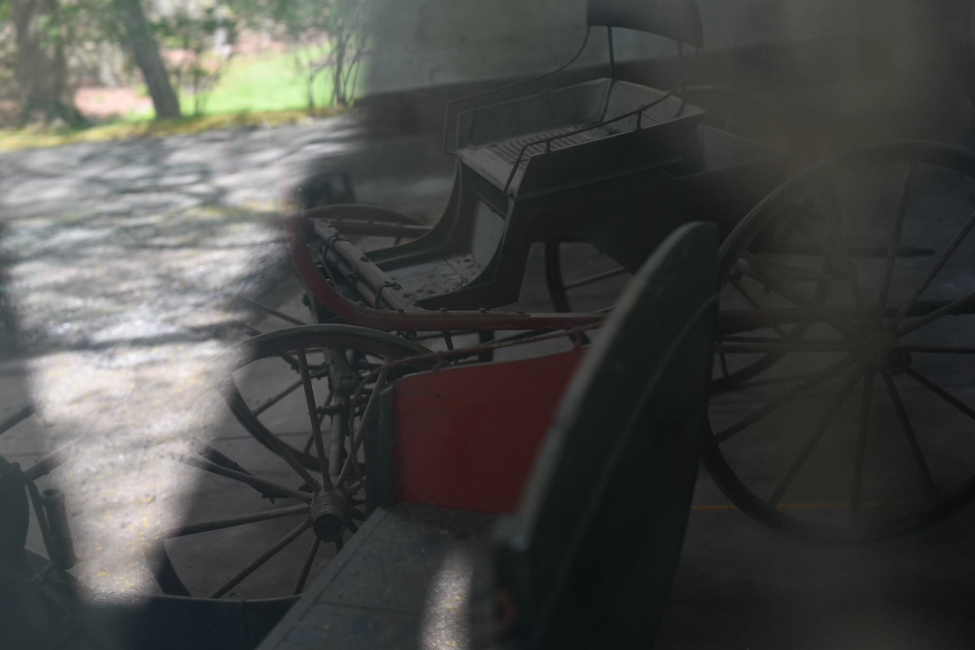inside the carriage house, there are carriages