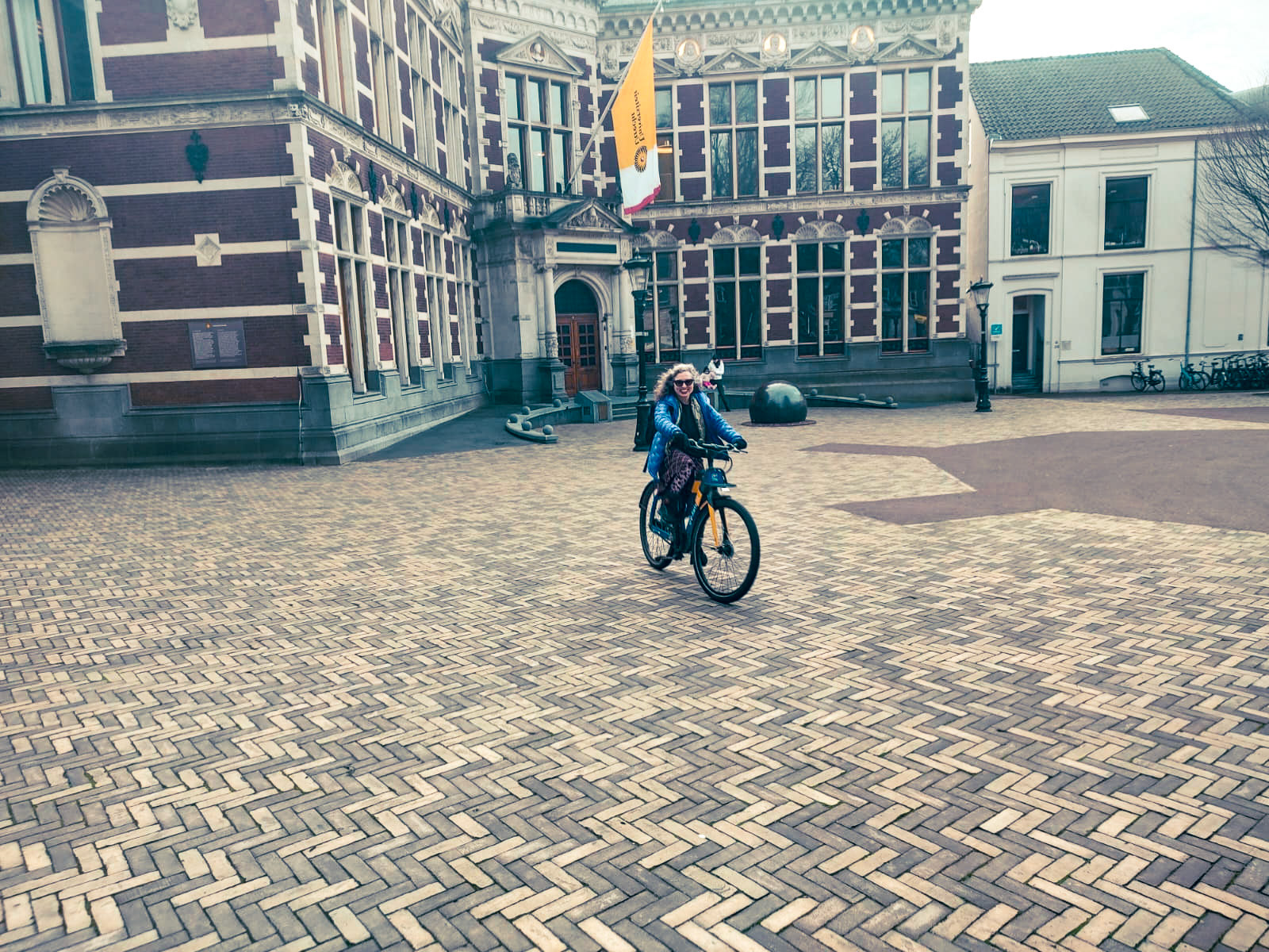 Utrecht plaza near the Dom tower and also the building behind me belongs to Utrecht University and was recently featured in a photo of many professors on bicycles on social media