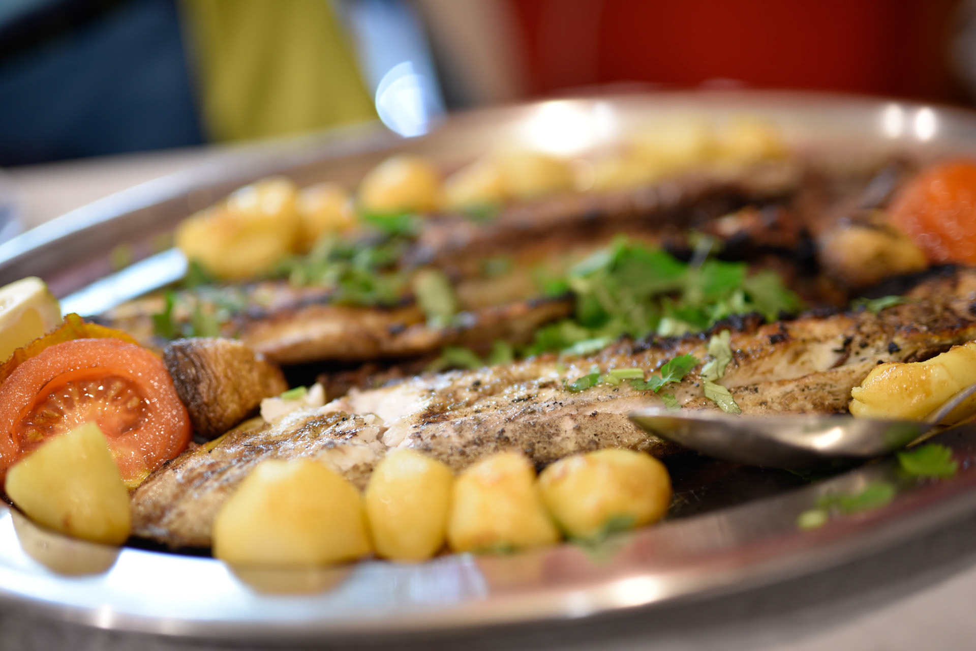 Grilled fish, potatos, and tomatos