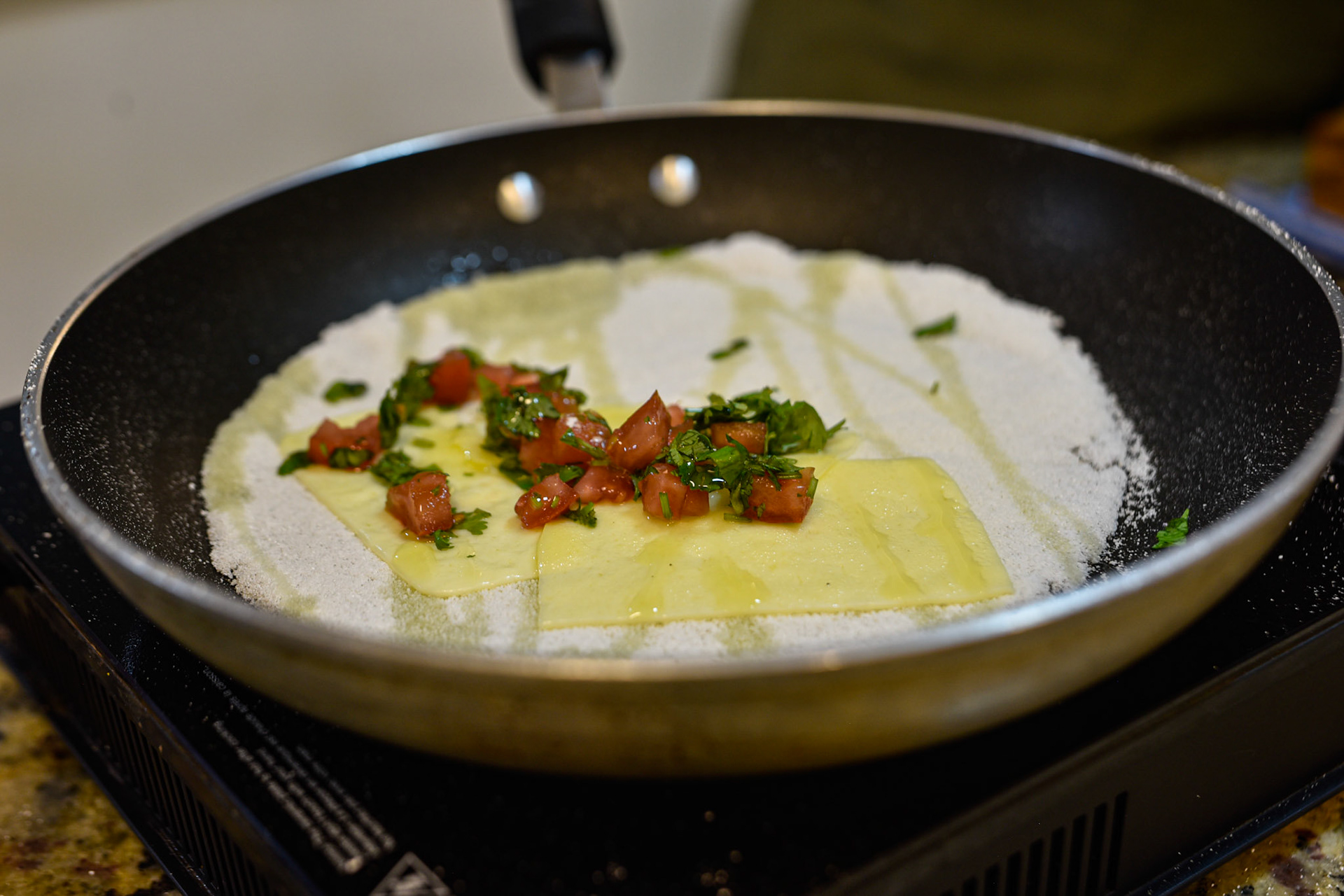 tapioca flour in a dry pan, drizzled with oil, tomato and basil
