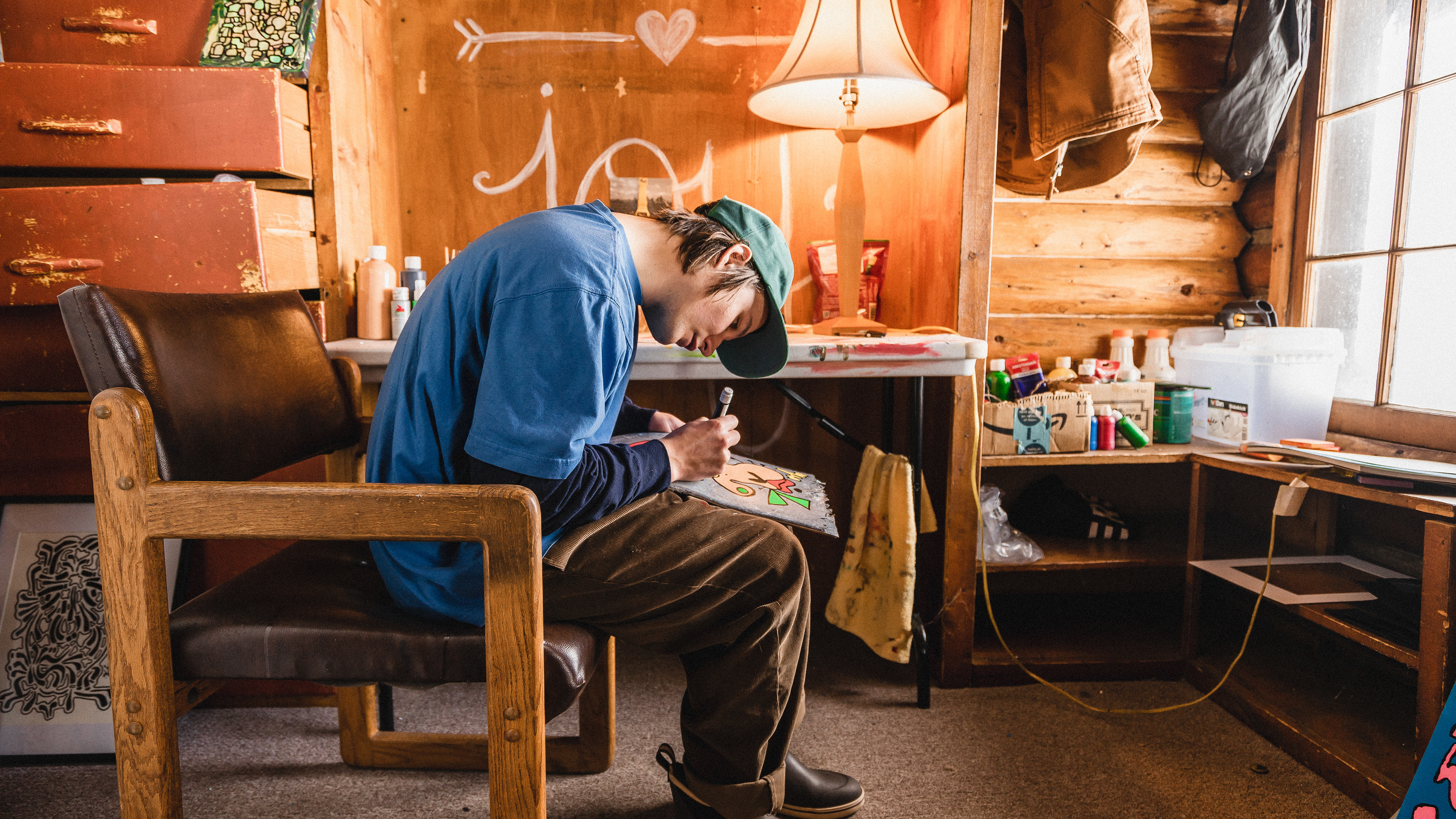 Jared Bennett in his lil' studio, putting finishing touches on an old, broken skateboard deck. Jared is an artist and skateboarder in Steamboat Springs, CO.