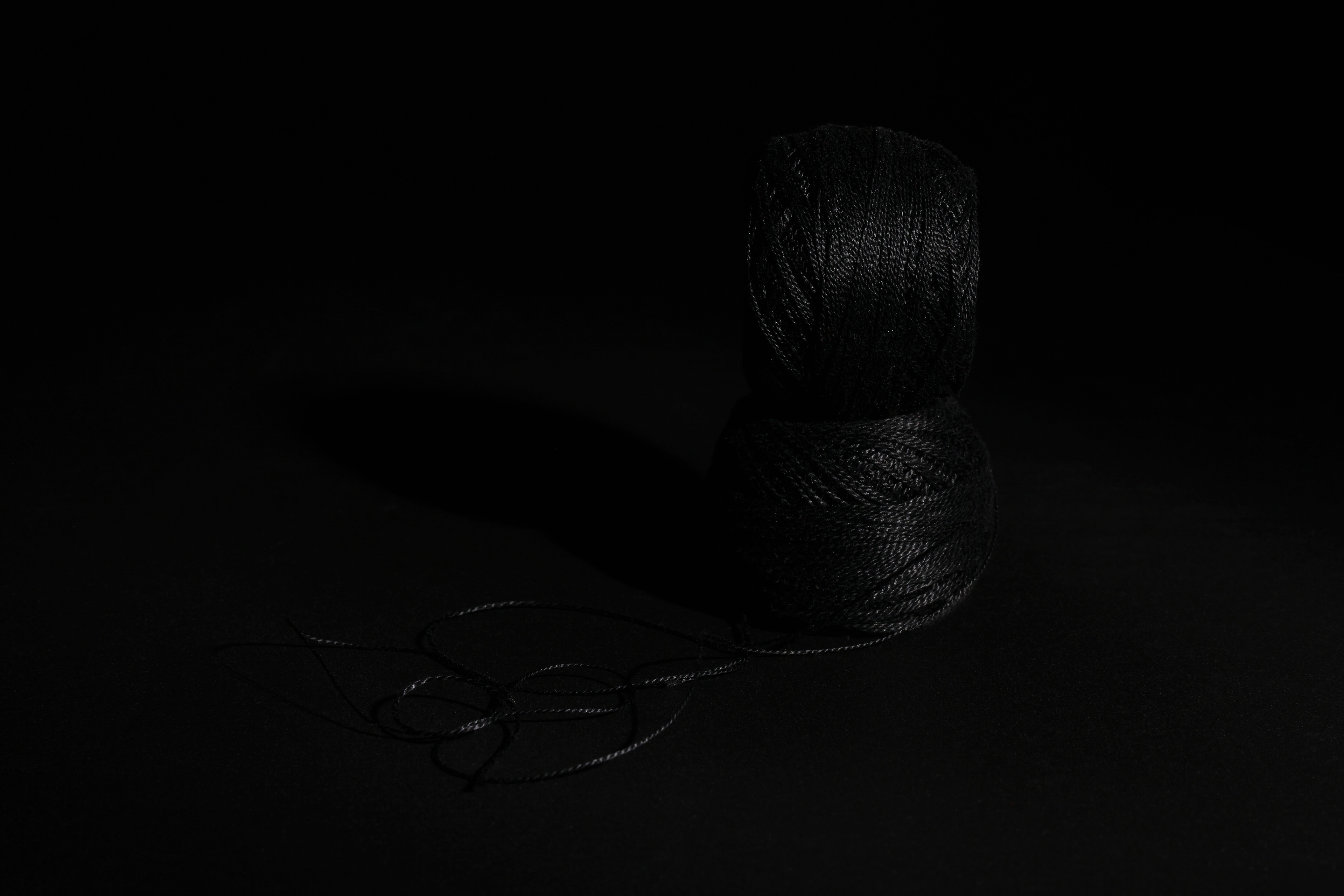 Black Embroidery Thread against Black Background