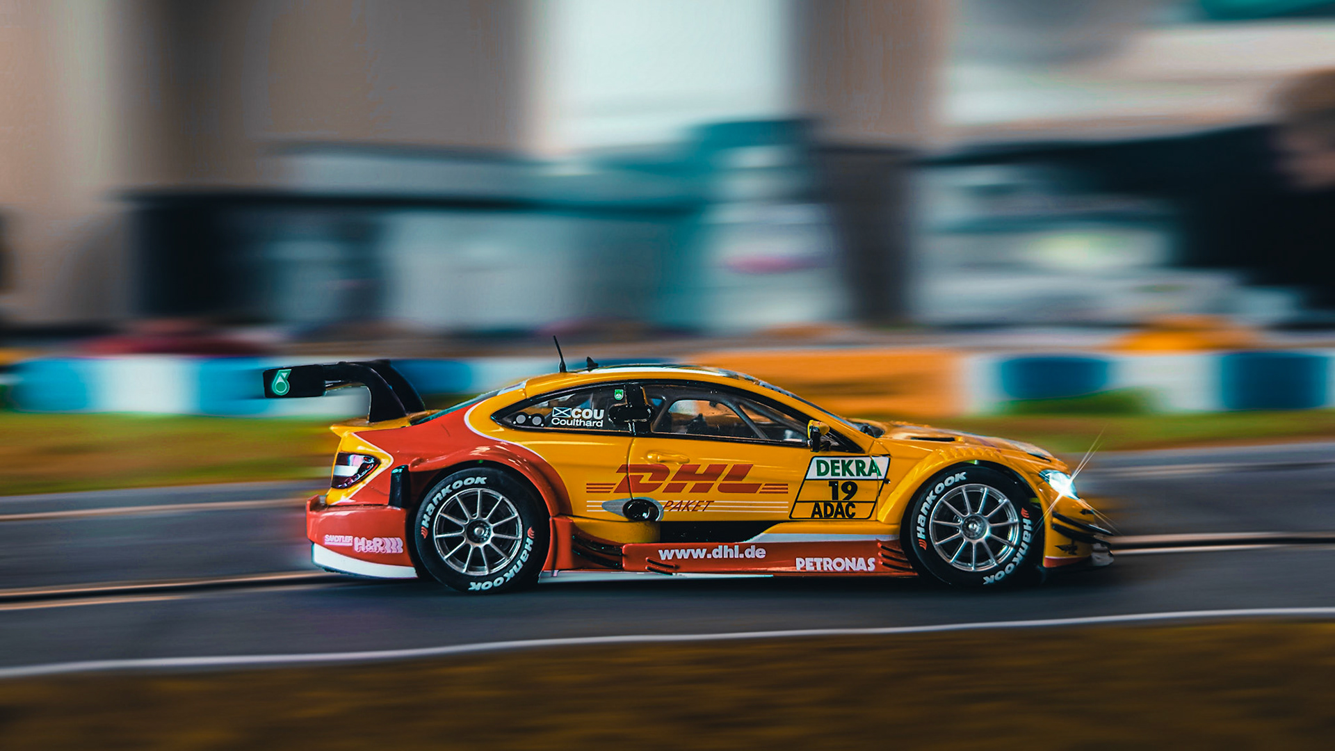 Velocity, delivered. The DHL-liveried Mercedes DTM machine—where speed meets spectacle.