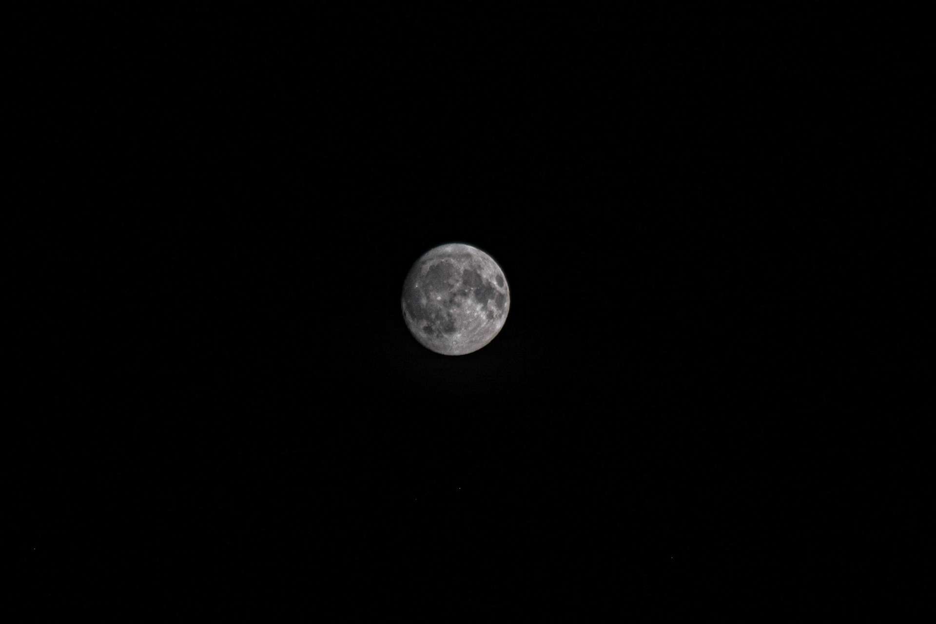 Silent sentinel in the night – the moon in full clarity, hanging in infinite black
