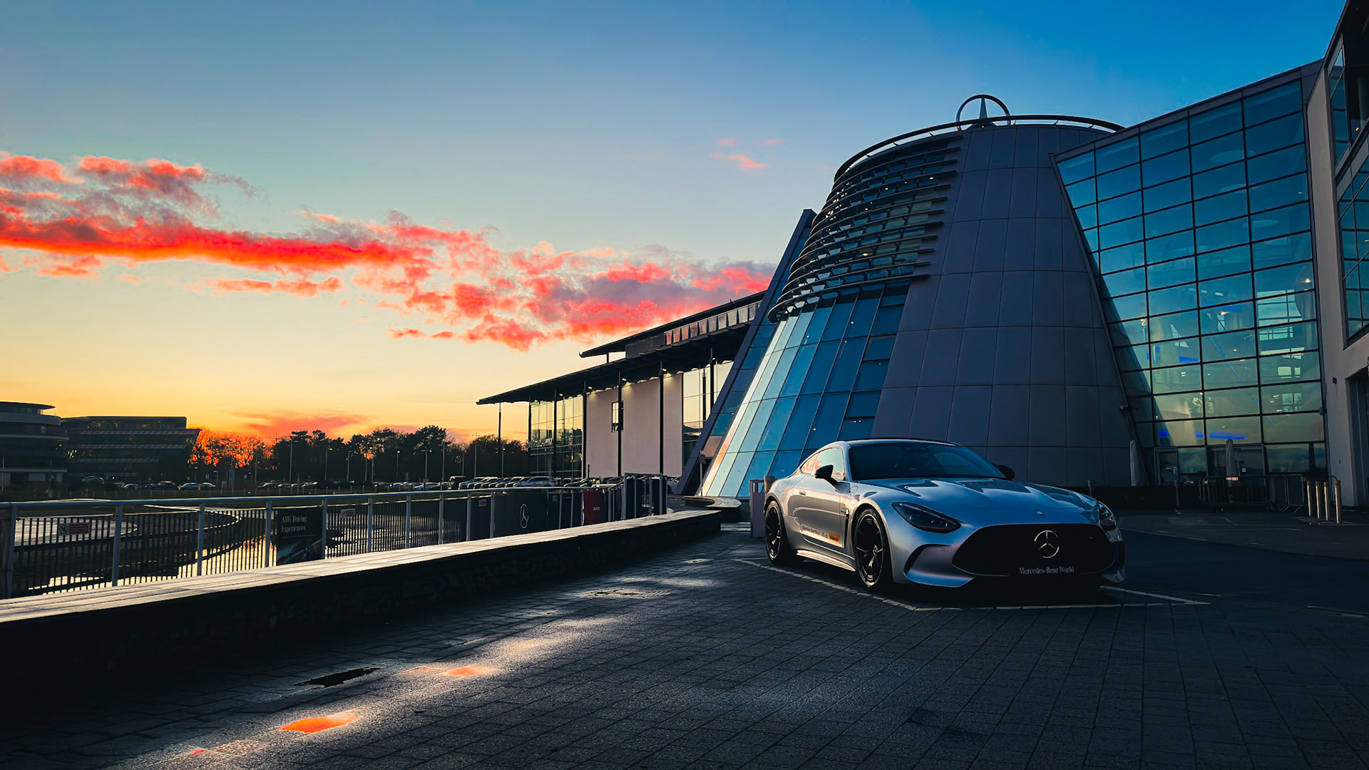 Golden hour perfection – the AMG GT silhouette against a Surrey sunset, where architecture and adrenaline collide