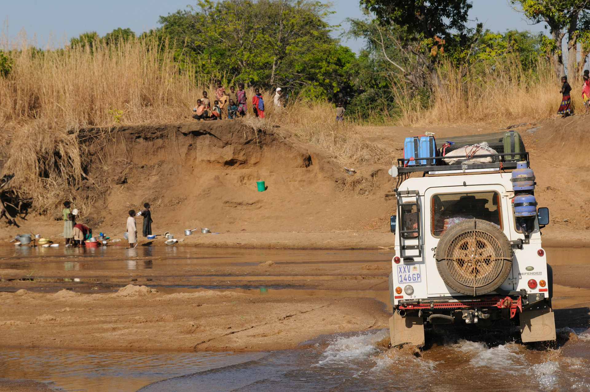 Crossing a river, being watched by the locals