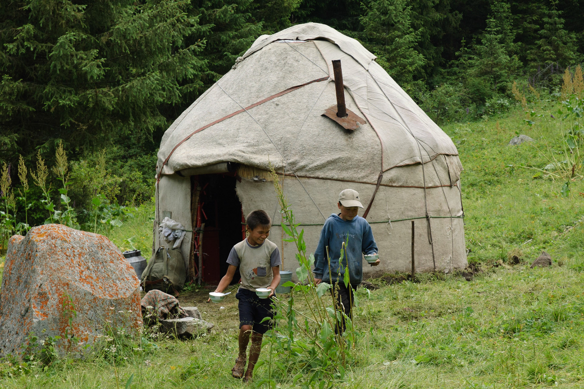 boys offering yoghurt from small yurt, Karakol valley