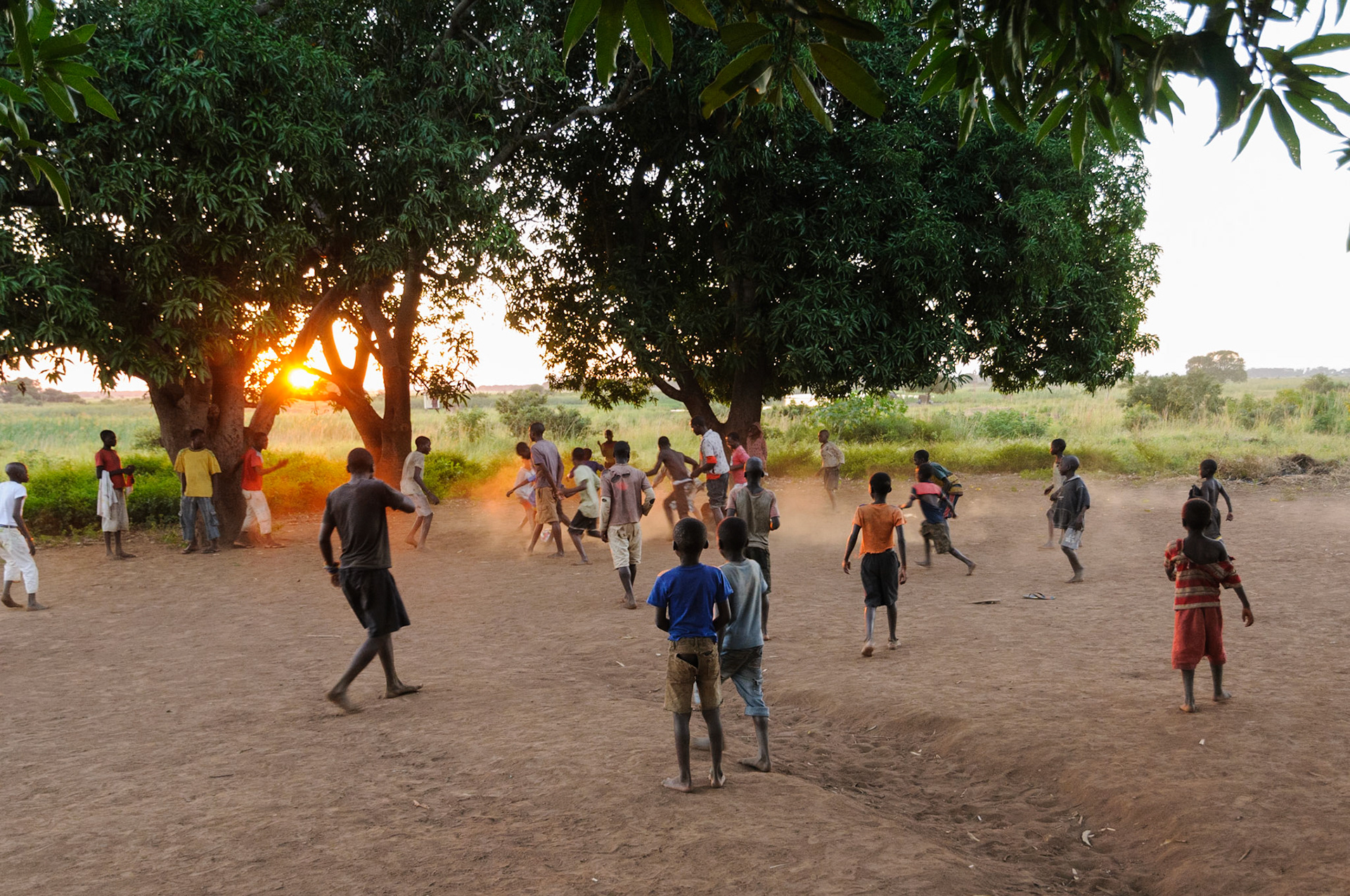 Village football game at sunset