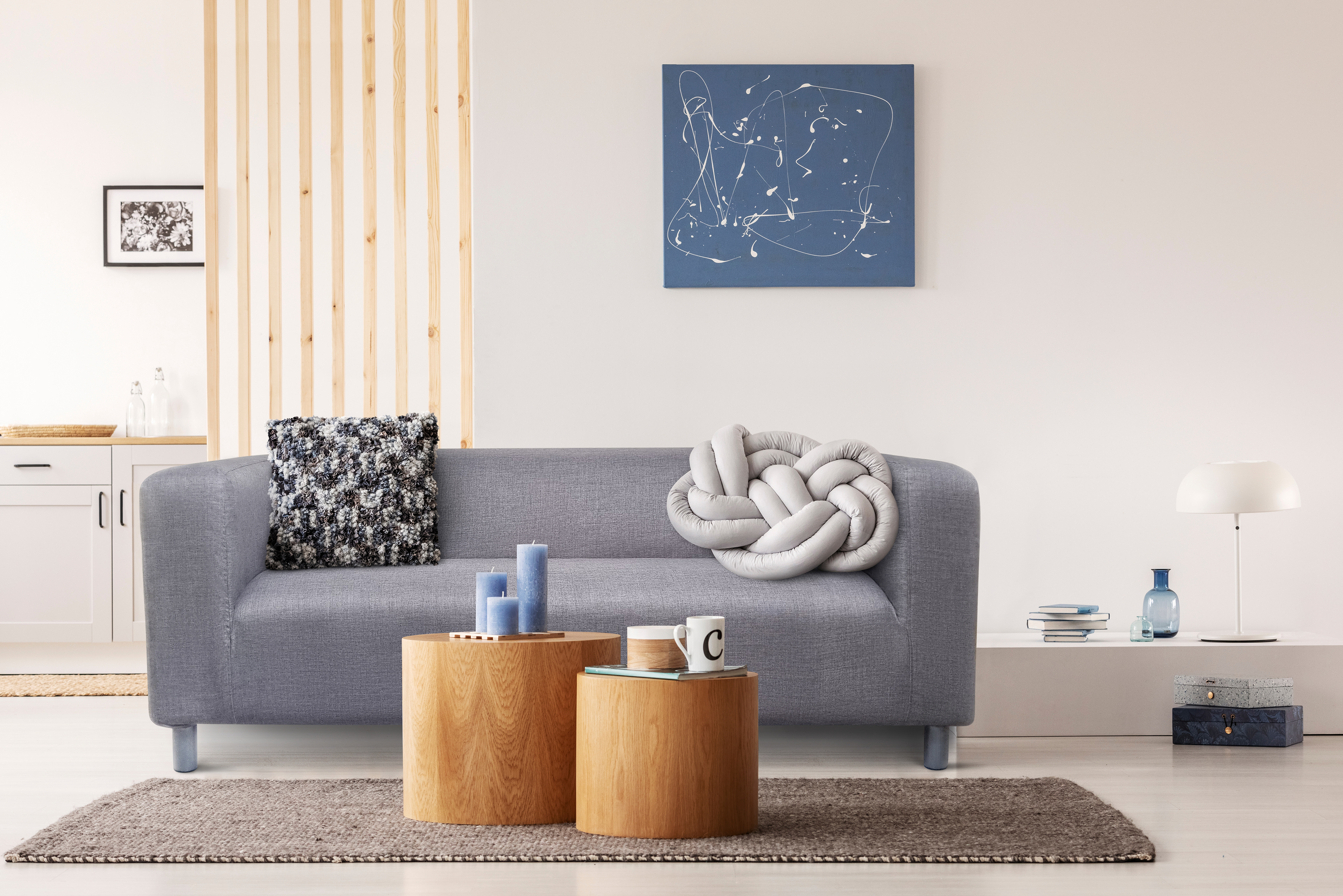 Modern living room with grey sofa in creamy colors with wooden and beige accents.