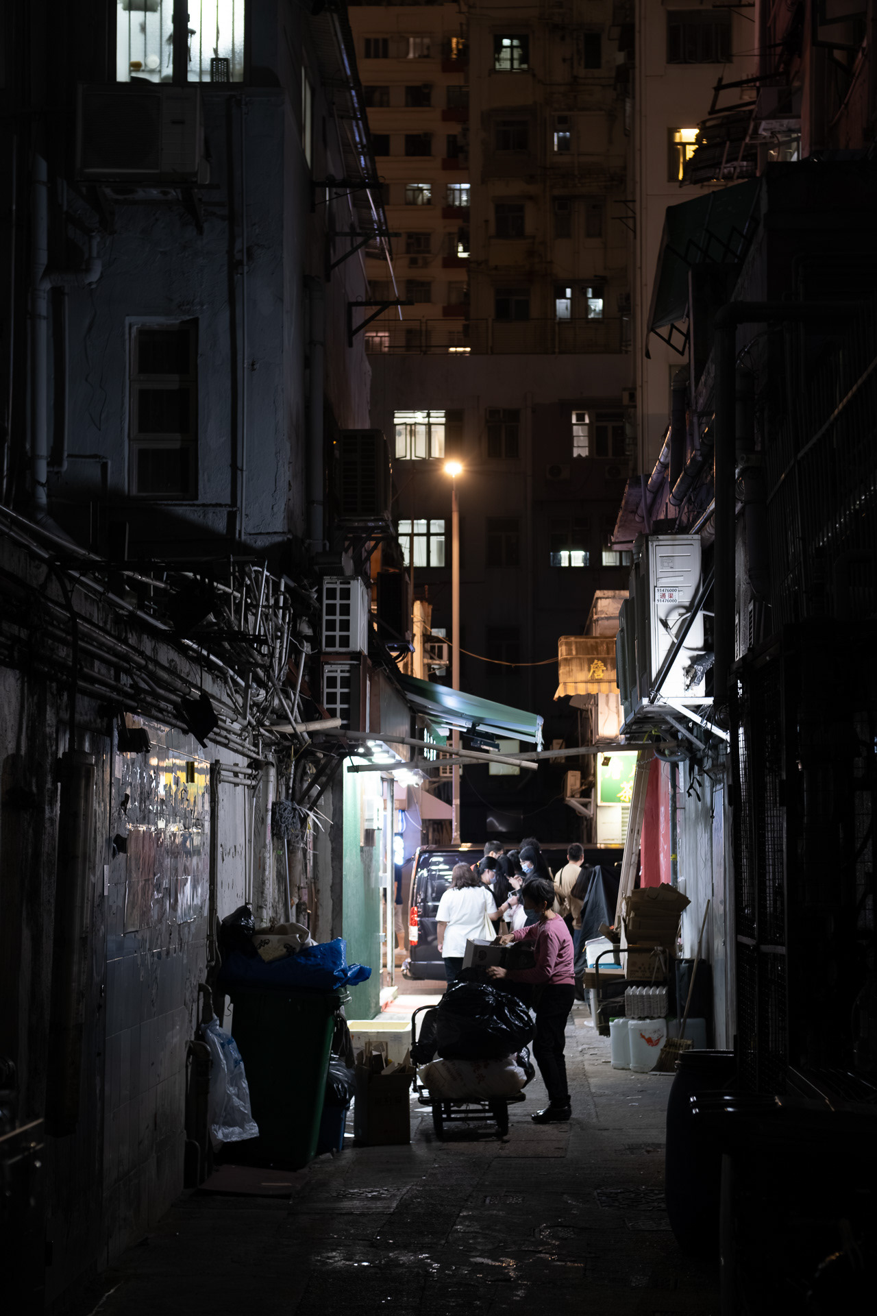 Worker in Hong Kong Night Alleyways