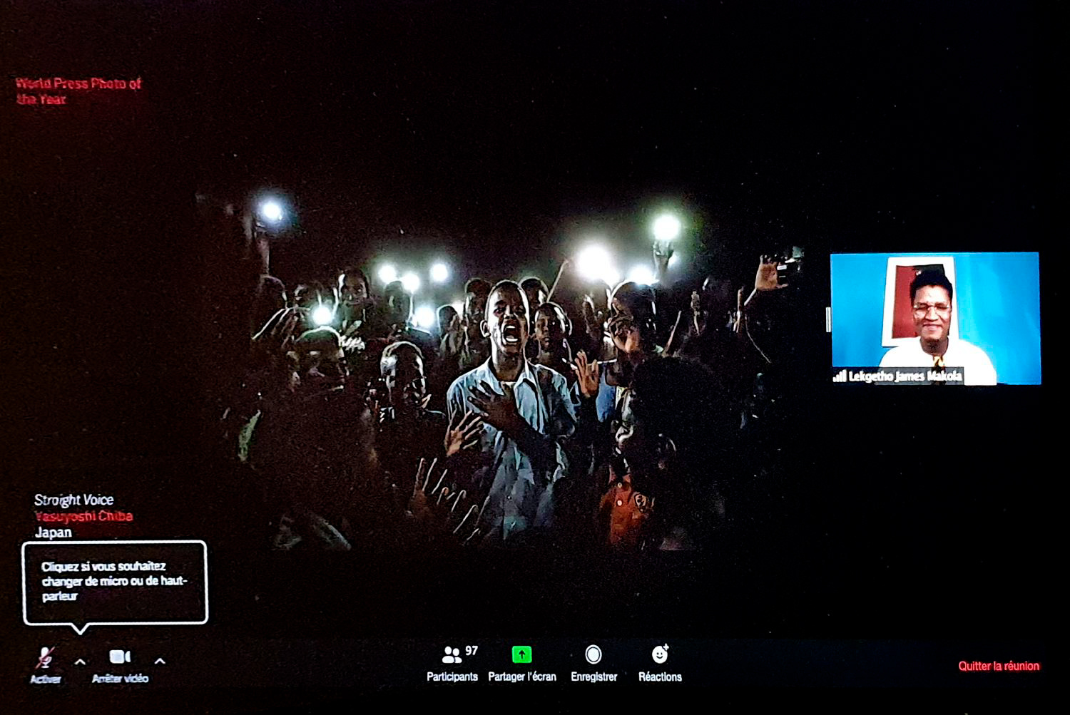 Yasuyoshi Chiba, World Press Photo of the Year. 19 June, 2019, A young man, illuminated by mobile phones, recites protest poetry while demonstrators chant slogans calling for civilian rule, during a blackout in Khartoum, Sudan.