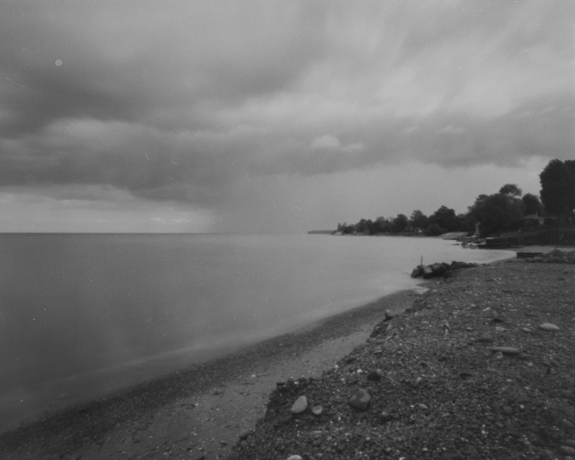 After Wellspring 2024, I stopped by Lake Erie, which is only about two miles from the site of the festival. I watched the rain and grabbed my pinhole camera, and captured a shot of the receeding rain off to the east. f/231, 75mm, 9sec. Arista EDU Ultra 100 B+W 4x5 film