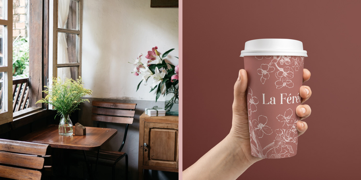 A rectangular image split down the middle with a pink bar to create two connected squares. On the left is a photograph of a wooden table with two chairs next an open window with flowers on the table. Next to one of the chairs is a small cupboard which is also wooden and has a big bouquet of pink and white flowers on top. This place is clearly a cafe. On the right side of the image is a caucasian hand holding up a to go coffee cup. The cupe itself is a solid dusty medium pink color that is covered in outline drawings of flowers that are a lighter pink. The name of the cafe, La Feree, is also featured on the cup.