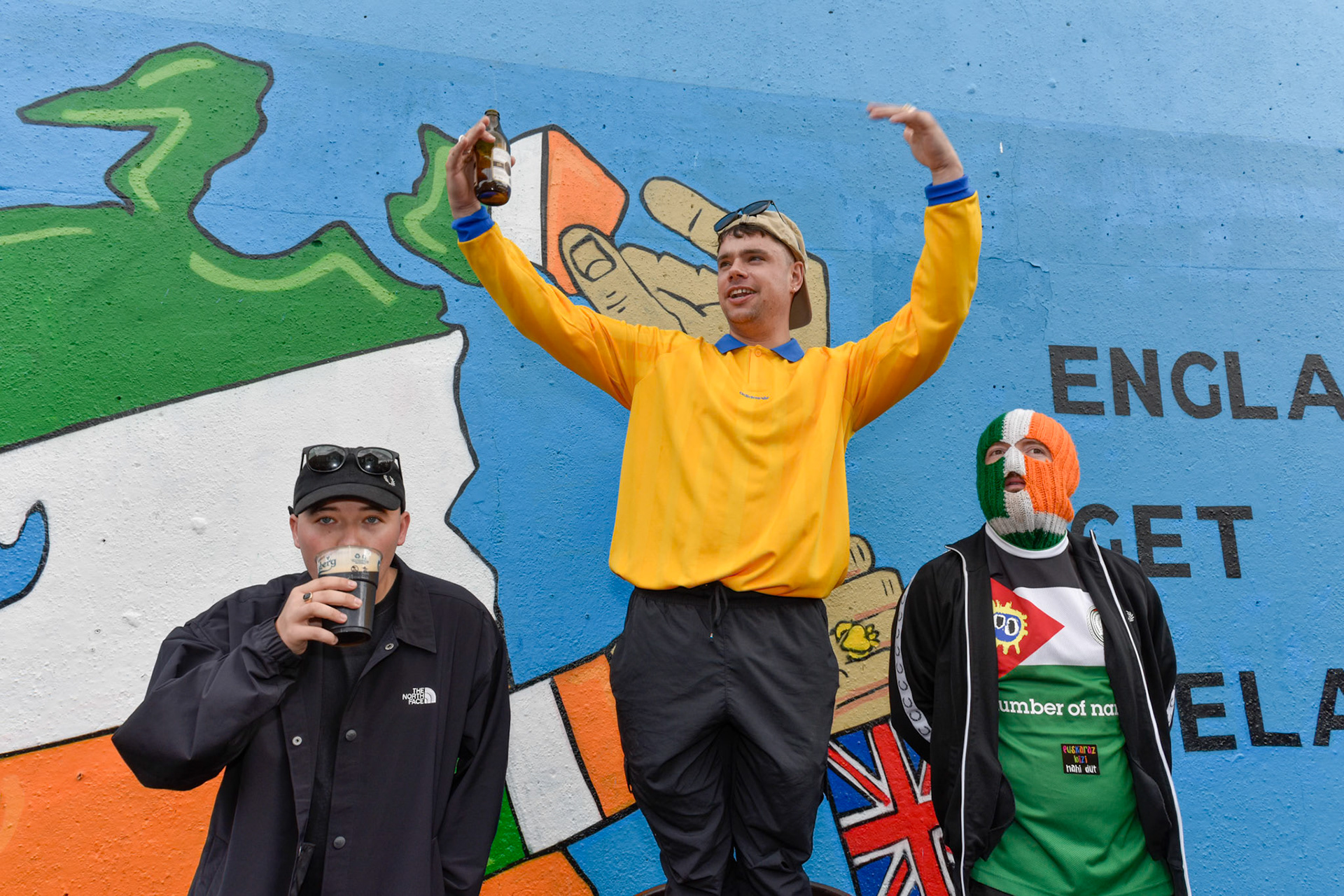 Kneecap at the unveiling ceremony of a new mural at:Hawthorn Bar West Belfast,Friday 9th August 2024.The three members of the band mingled with spectators.