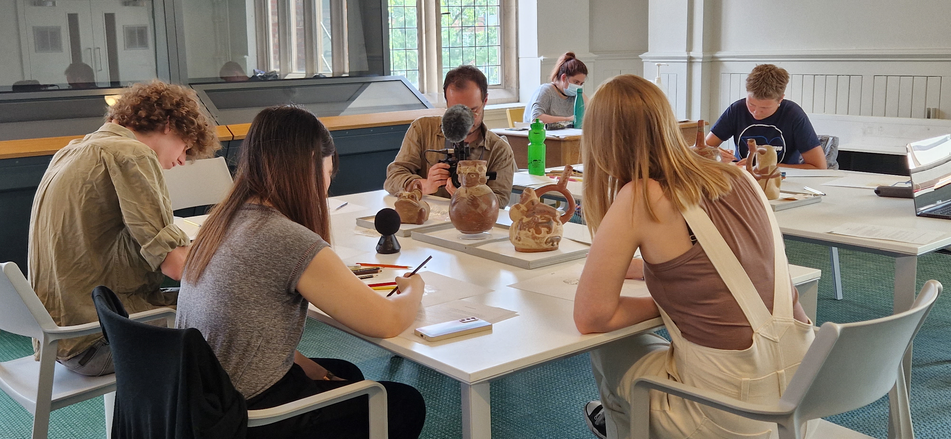 young adults drawing at Manchester Museum