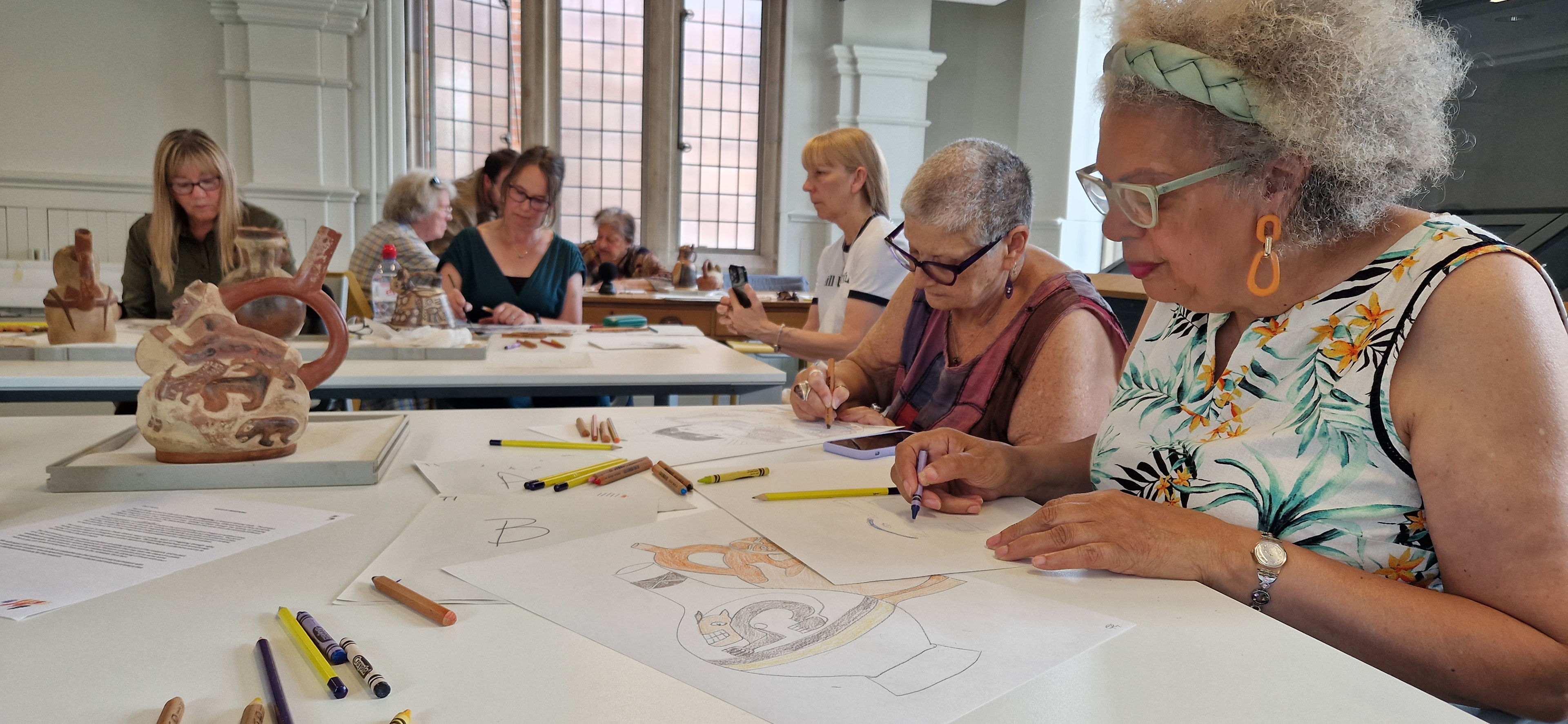 mature adults drawing at Manchester Museum