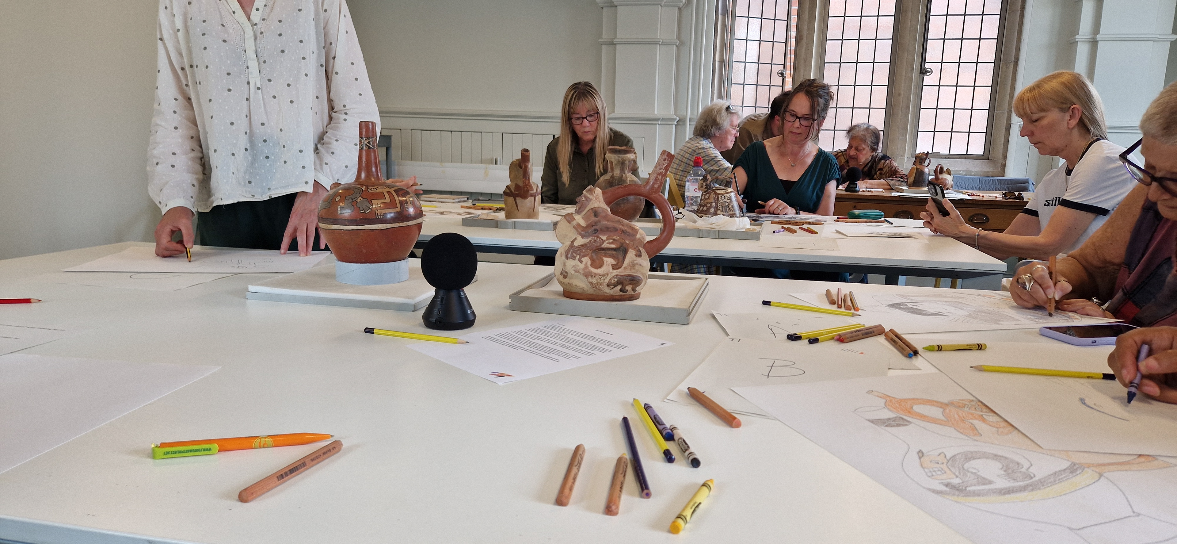 mature adults drawing at Manchester Museum