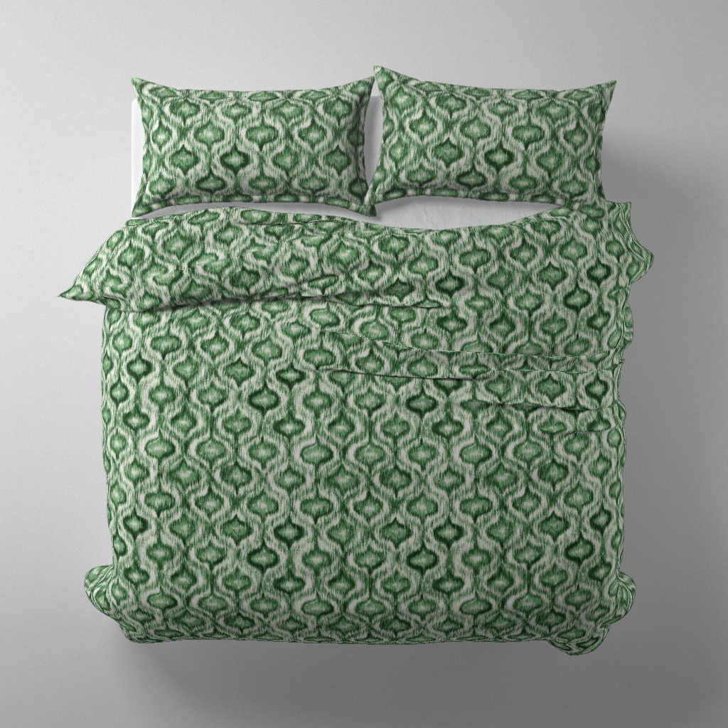 Duvet cover and pillow set mockup in Boho Style Ikat Ogee forest green colourway on a styled bed, by Lemon Dessin