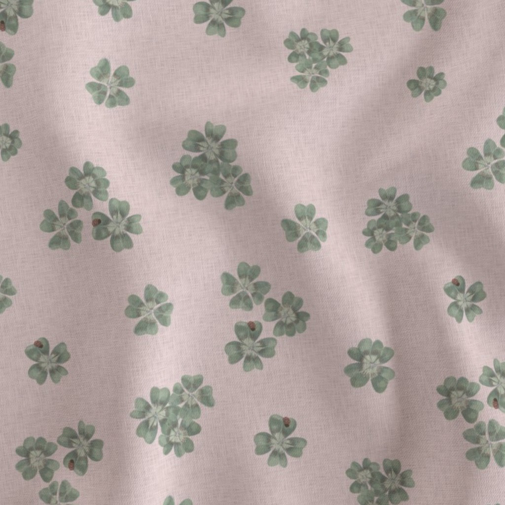 Flat fabric swatch showing Clover Scatter repeat pattern in blush pink colourway, sage green clover motifs on soft blush ground