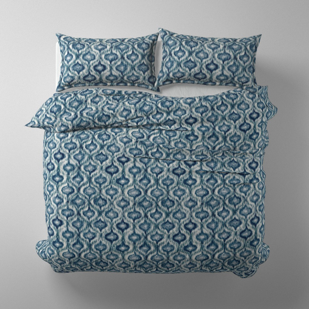 Duvet cover and pillow set mockup in Boho Style Ikat Ogee indigo blue colourway on a styled bed, by Lemon Dessin