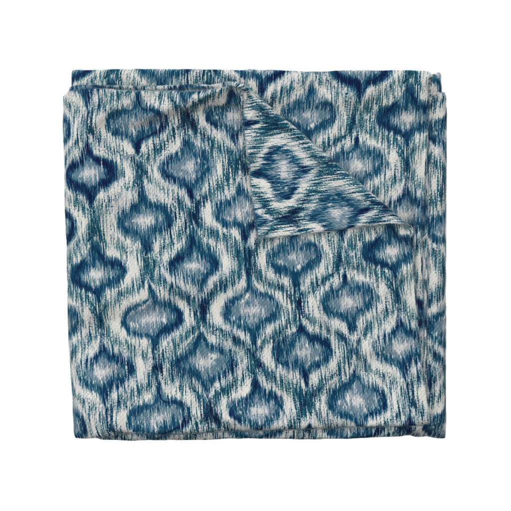 olded fabric swatch of Boho Style Ikat Ogee in indigo blue, showing the allover ogee repeat pattern, by Lemon Dessin