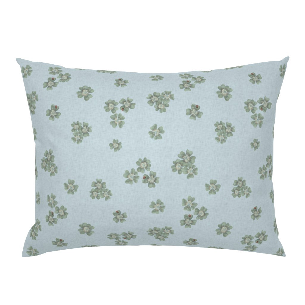 Square cushion cover in Clover Scatter powder blue colourway with botanical clover scatter print, on a white background