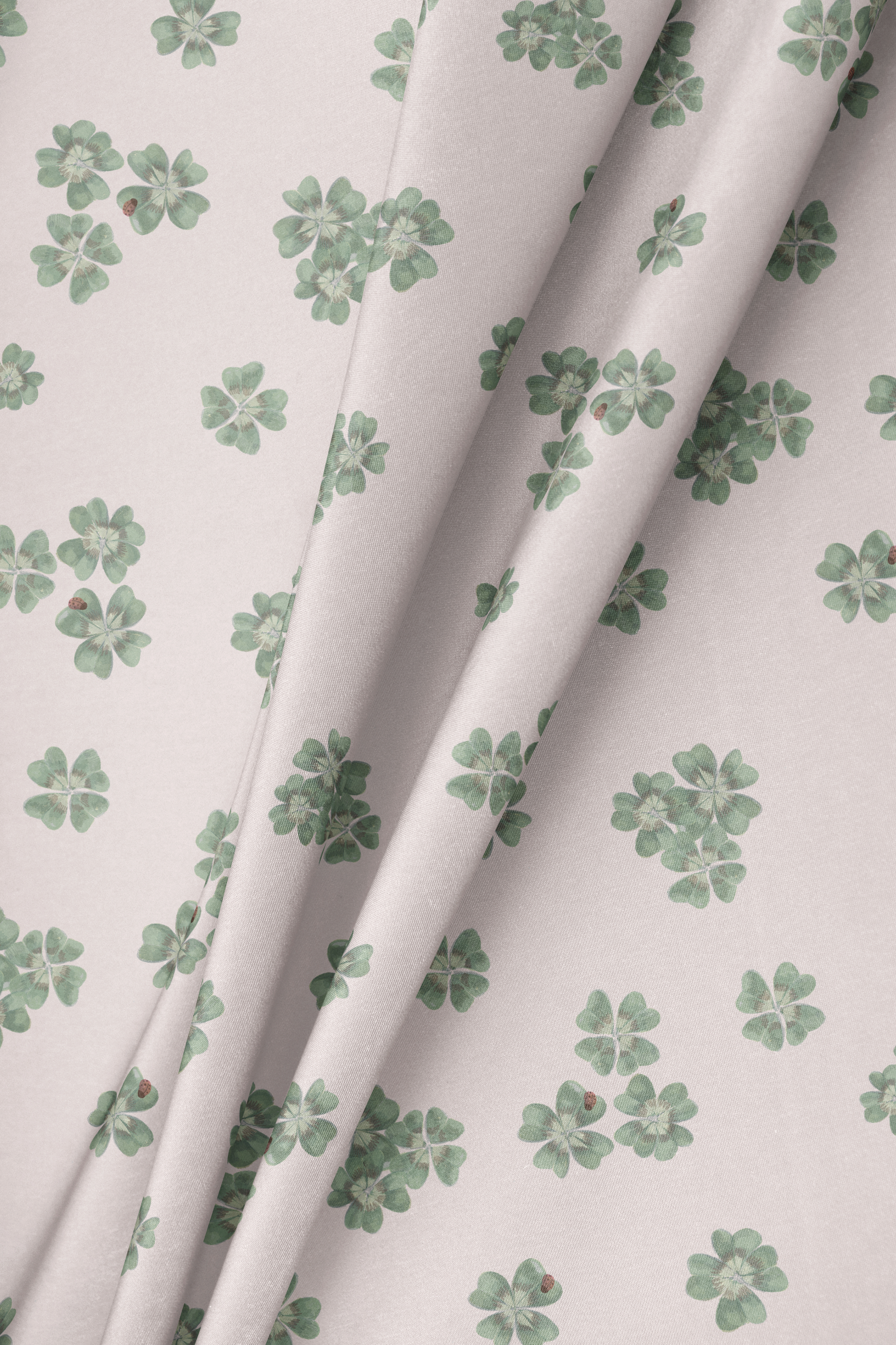 Draped fabric in Clover Scatter blush pink colourway folded to show pattern and soft texture