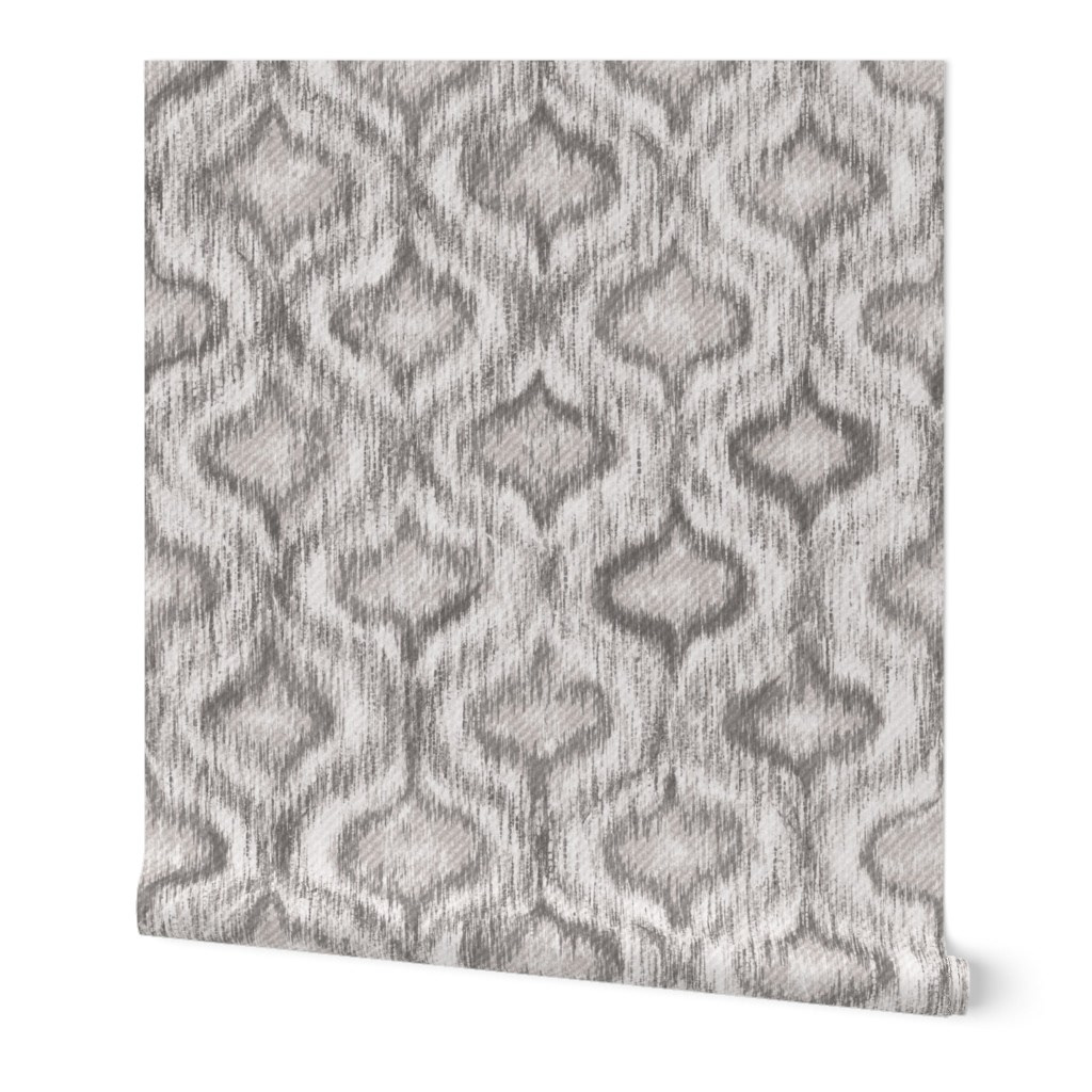 Flat pattern swatch of boho style ikat ogee wallpaper in warm grey and greige, showing the allover ogee repeat with soft ikat bleed detail