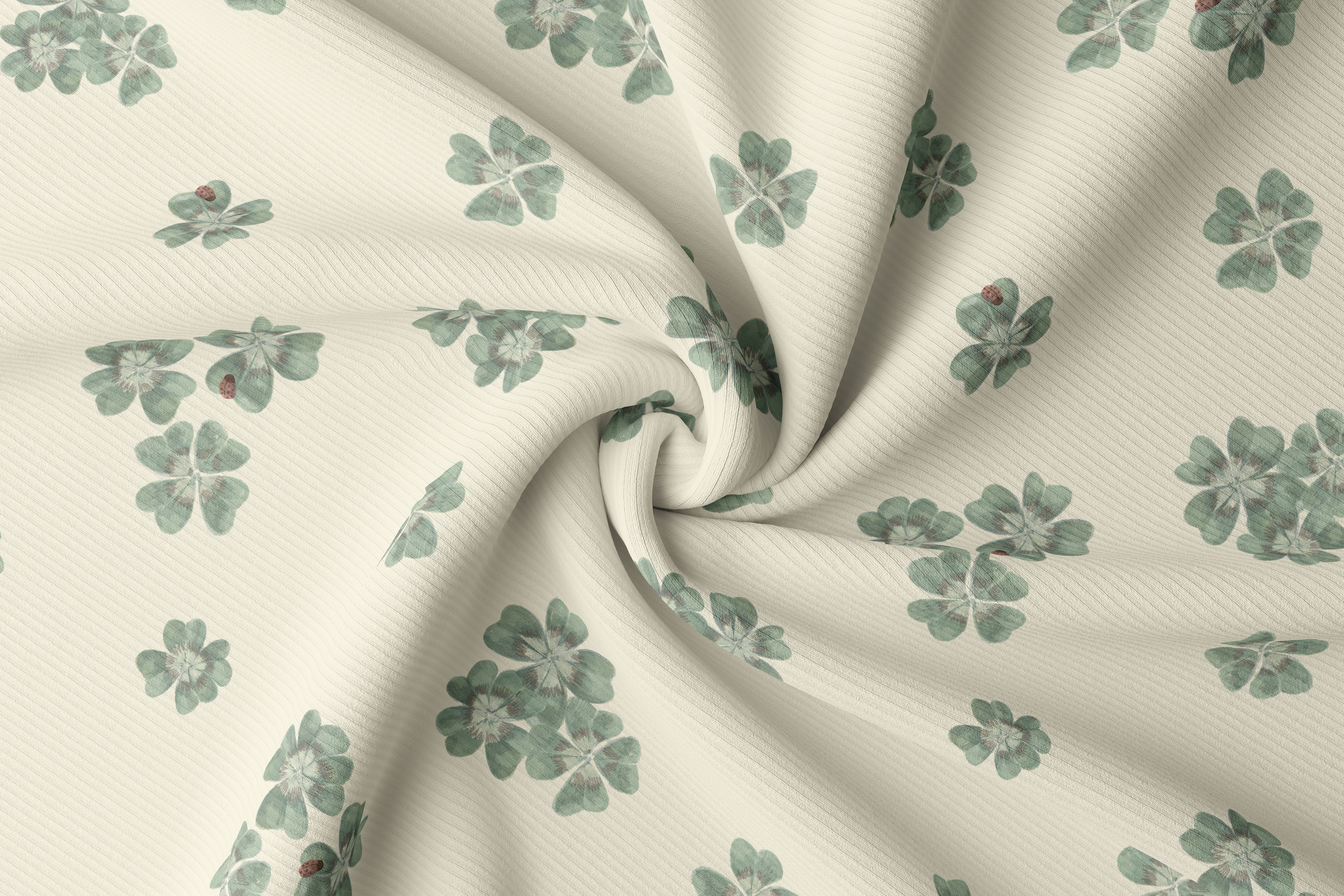 Close-up of Clover Scatter fabric twisted to show drape and texture, in cream colourway with hand-painted sage green clover motifs