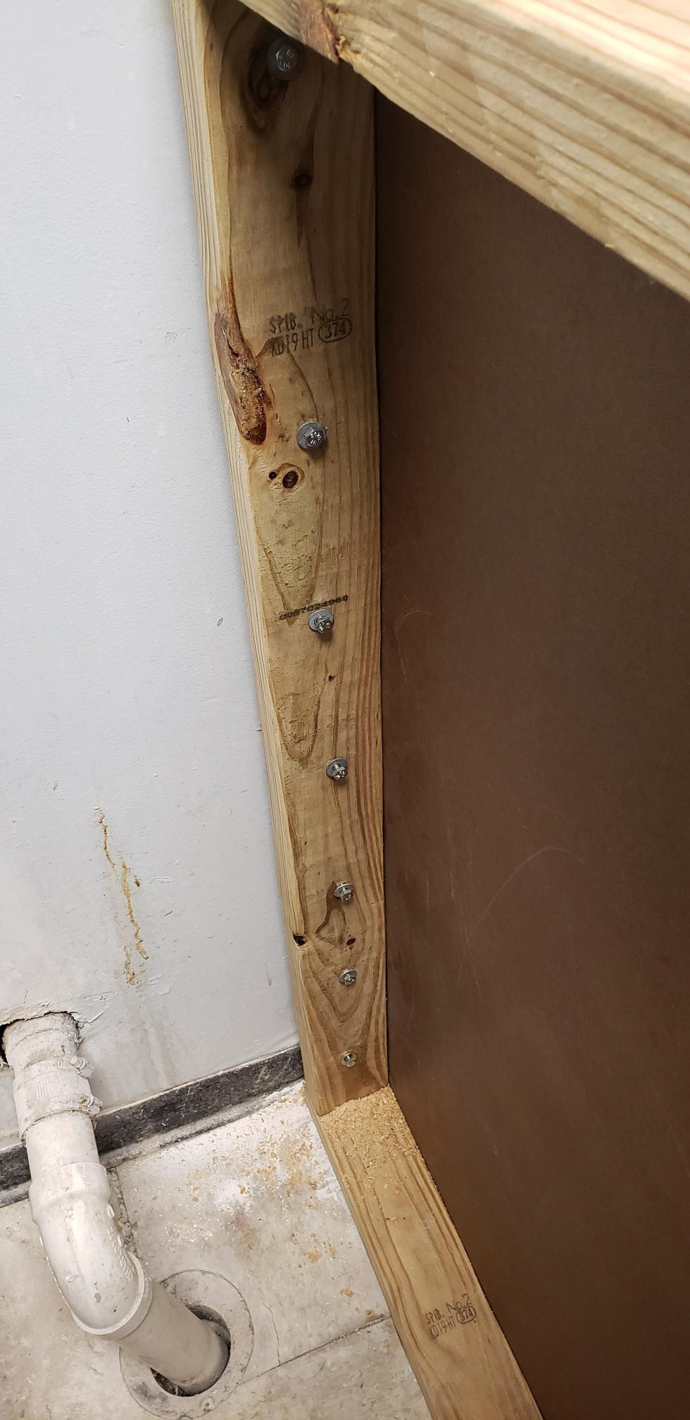 Aligning the bolts and tightening them down before enclosing this side of the knee wall