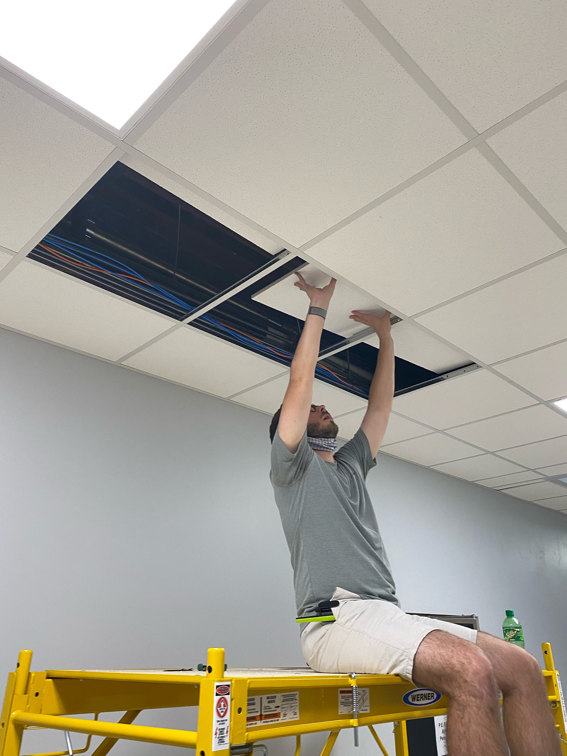 Ceiling tiles contain fiberglass so extra care is taken to place them.