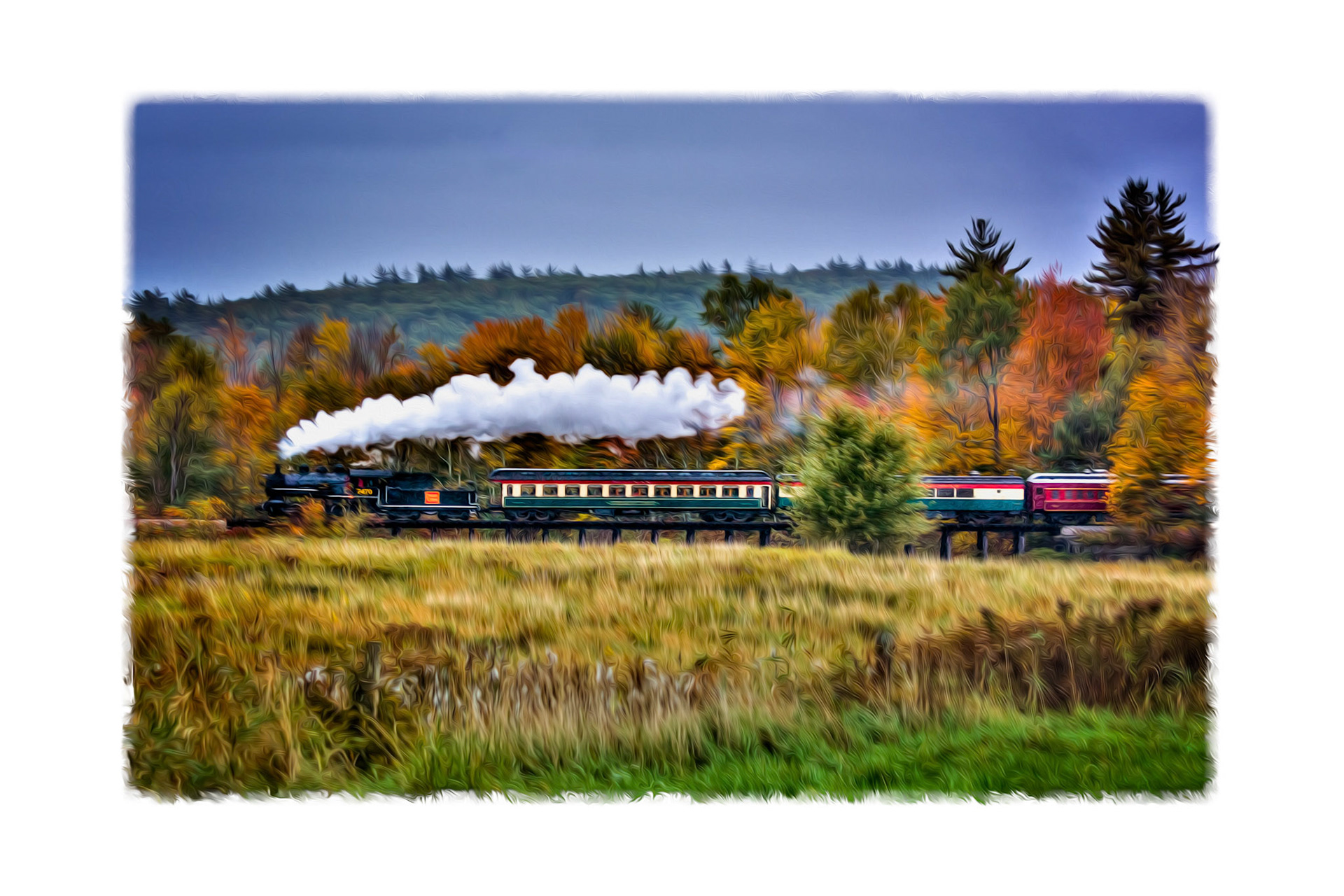 Conway Scenic Railroad Locomotive 7470 leads the train from Conway across Moat Brook Trestle at the height of fall color.