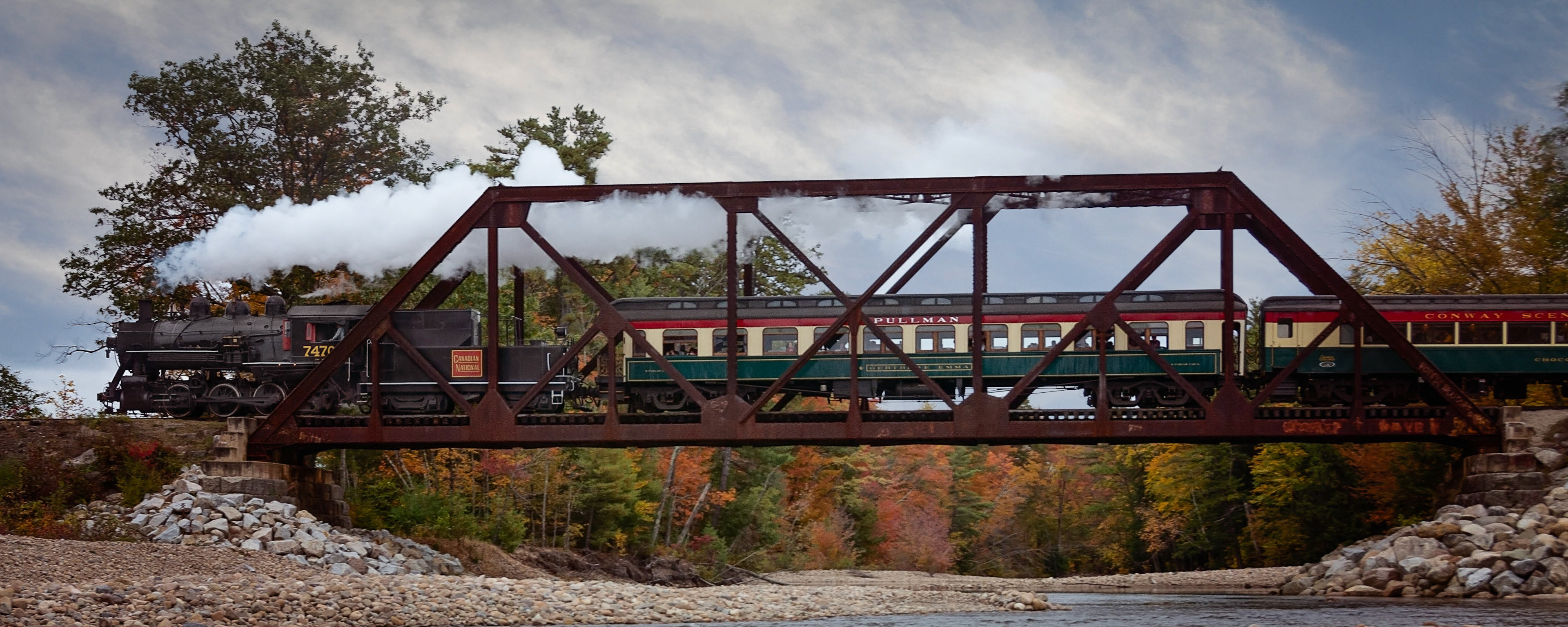 Conway Scenic Railroad Locomotive 7470 steams across the Swift River on the iron bridge.