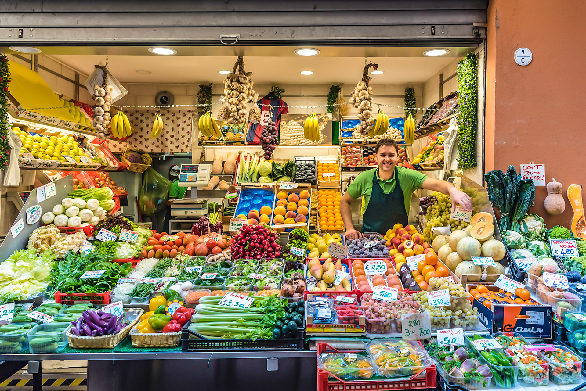 Produce retailer in the street market area of Bologna