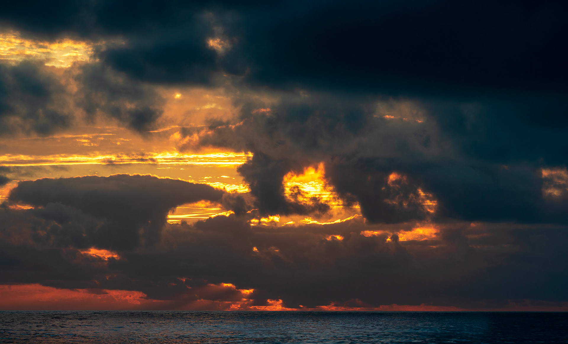 Setting sun sculping  storm clouds over the Pacific Ocean off Arch Cape beach