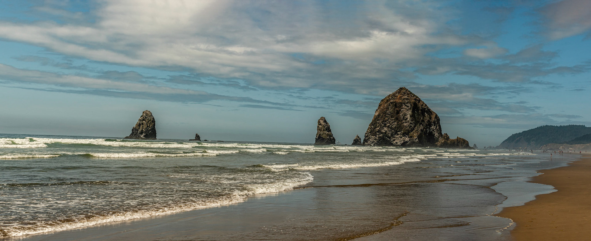 Haystack Rock and the Pinnacles with Tillamook Light in the Background